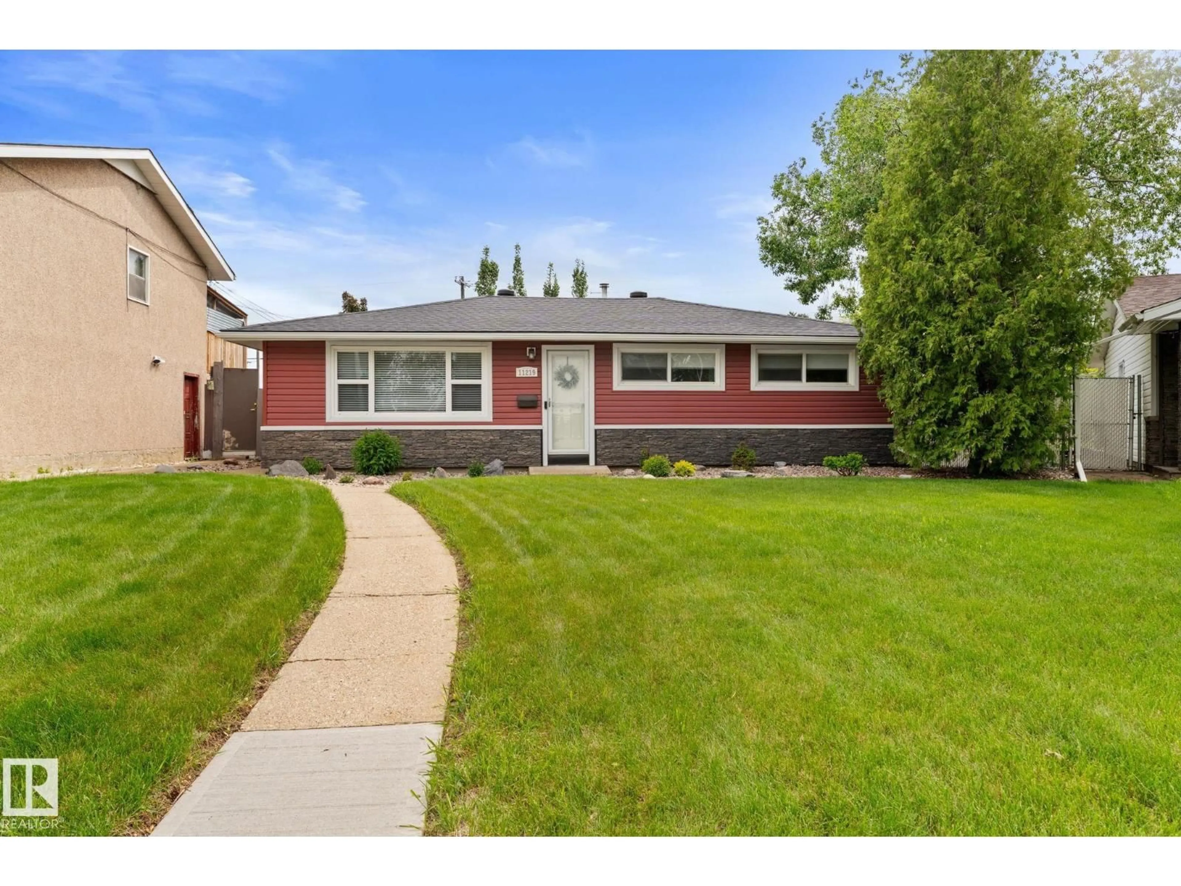 Home with vinyl exterior material, street for NW - 11219 134A AV, Edmonton Alberta T5E1M4
