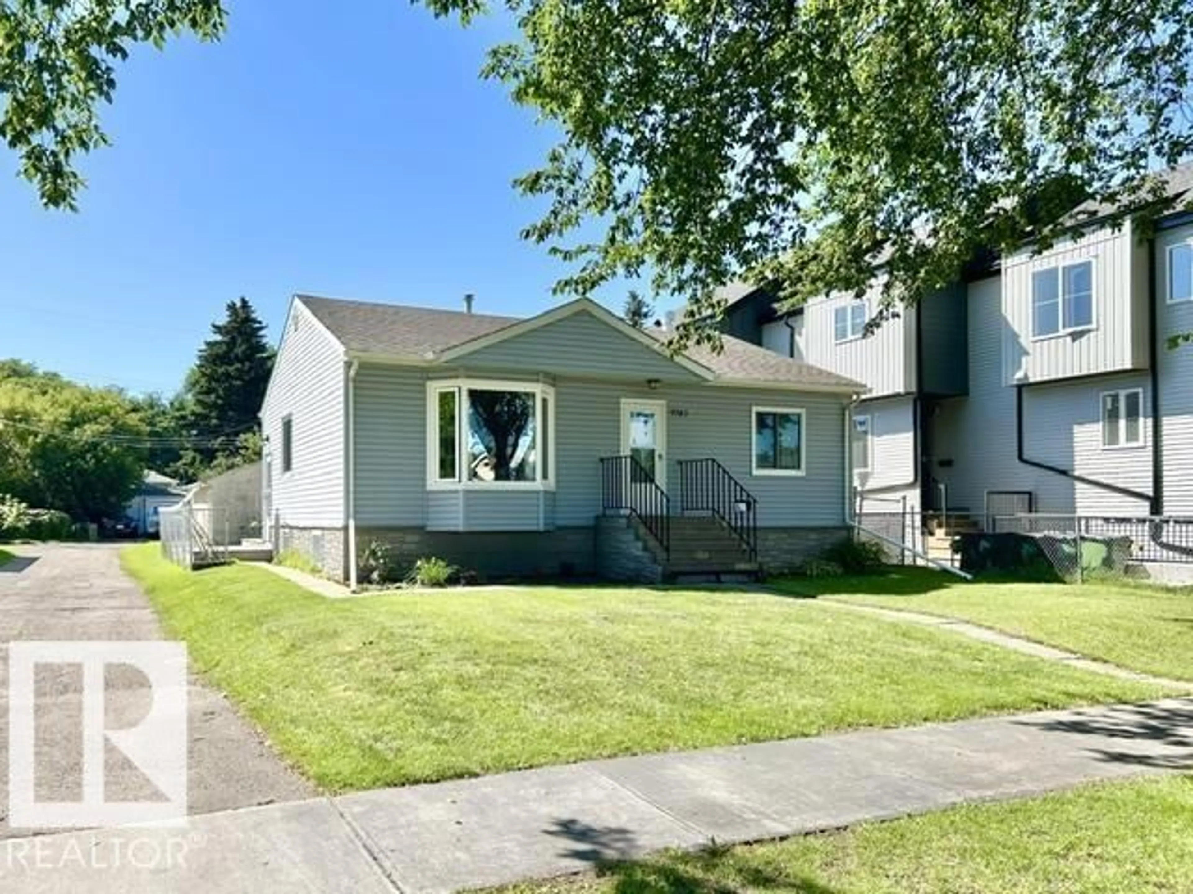 Home with vinyl exterior material, street for 9743 65 AV, Edmonton Alberta T6E0K5