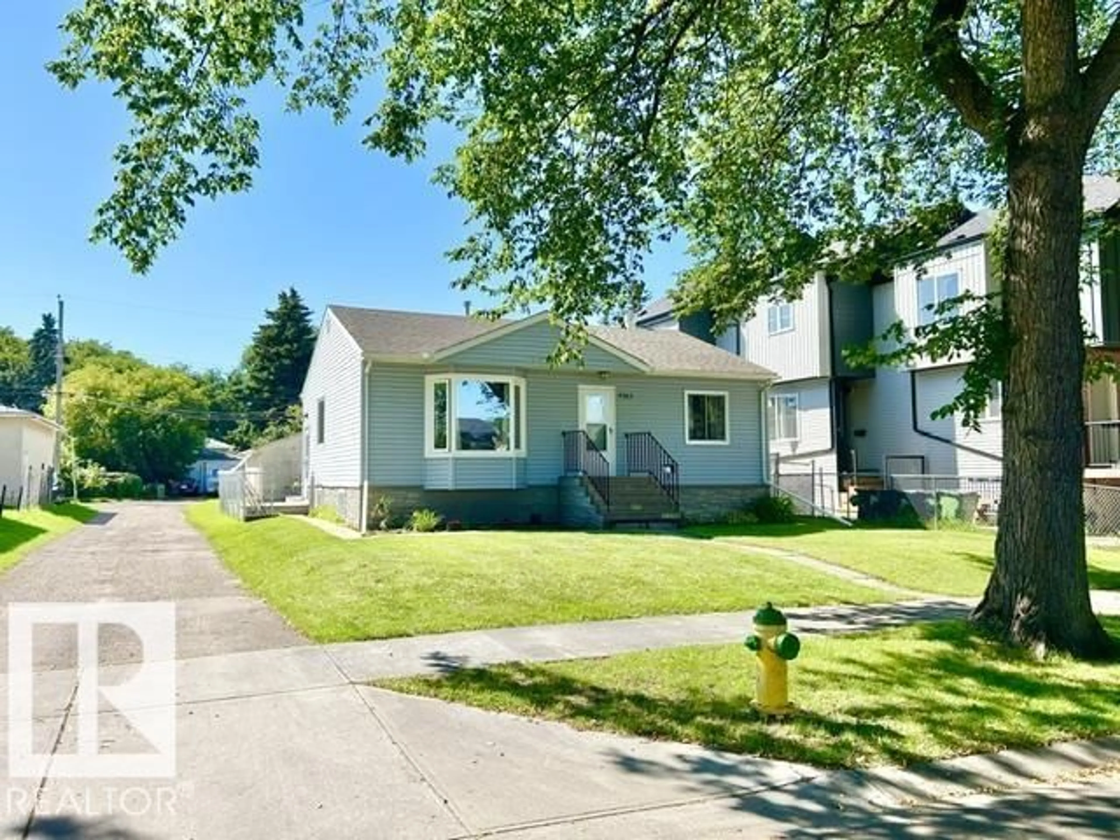 Home with vinyl exterior material, street for 9743 65 AV, Edmonton Alberta T6E0K5