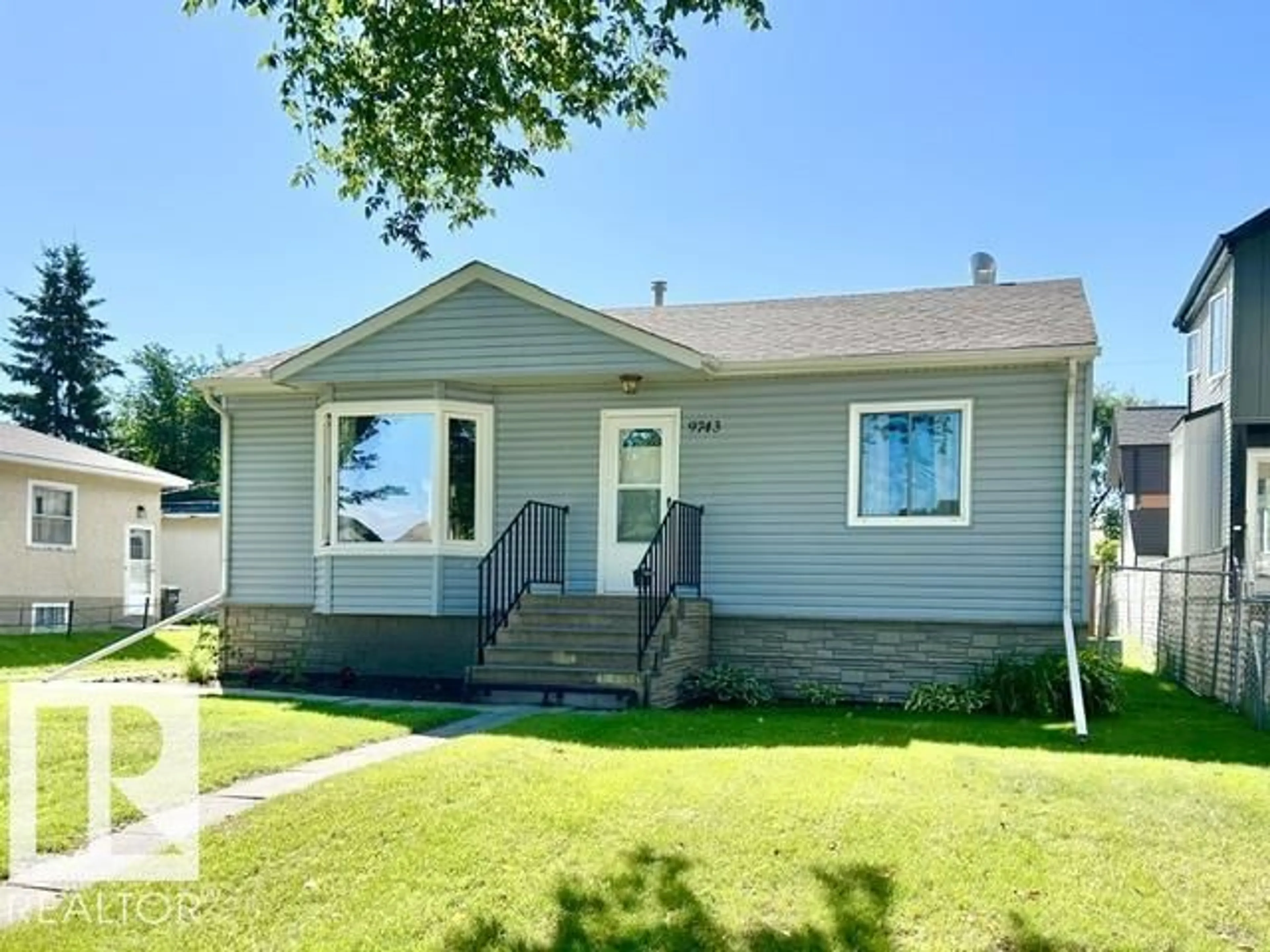 Home with vinyl exterior material, street for 9743 65 AV, Edmonton Alberta T6E0K5
