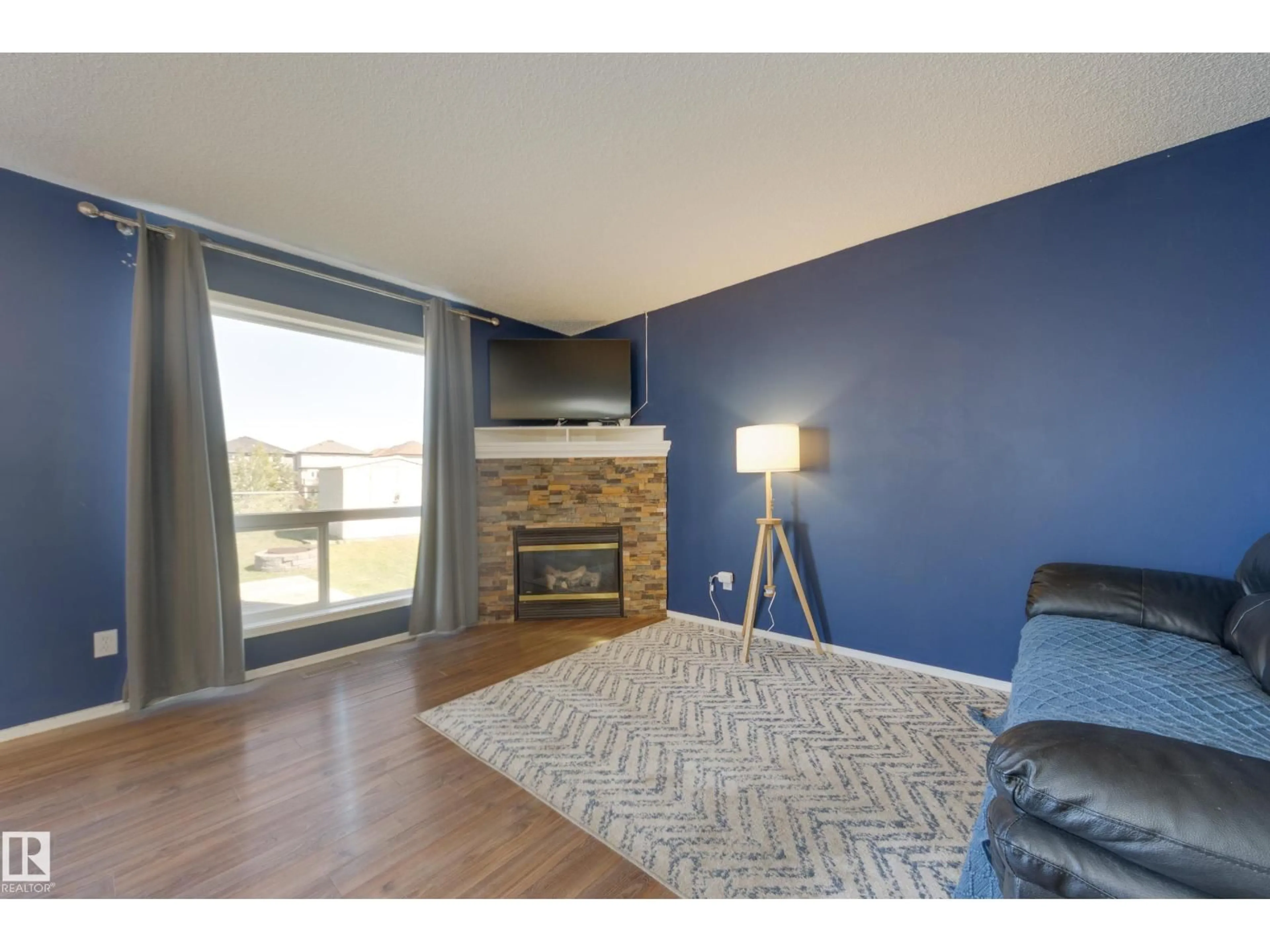 Living room with furniture, wood/laminate floor for 13086 162A AV, Edmonton Alberta T6V1W1