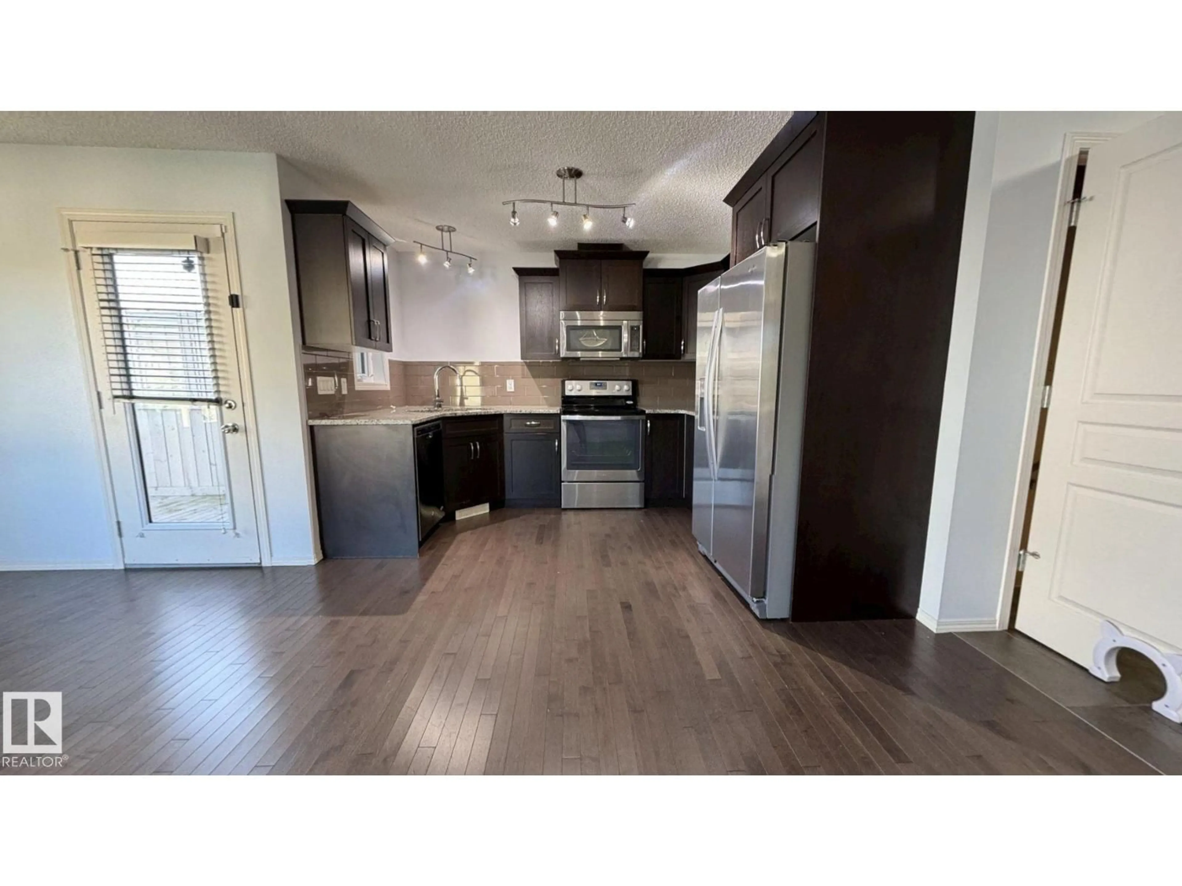 Open concept kitchen, wood/laminate floor for 20 ARALIA CV, Spruce Grove Alberta T7X0V4