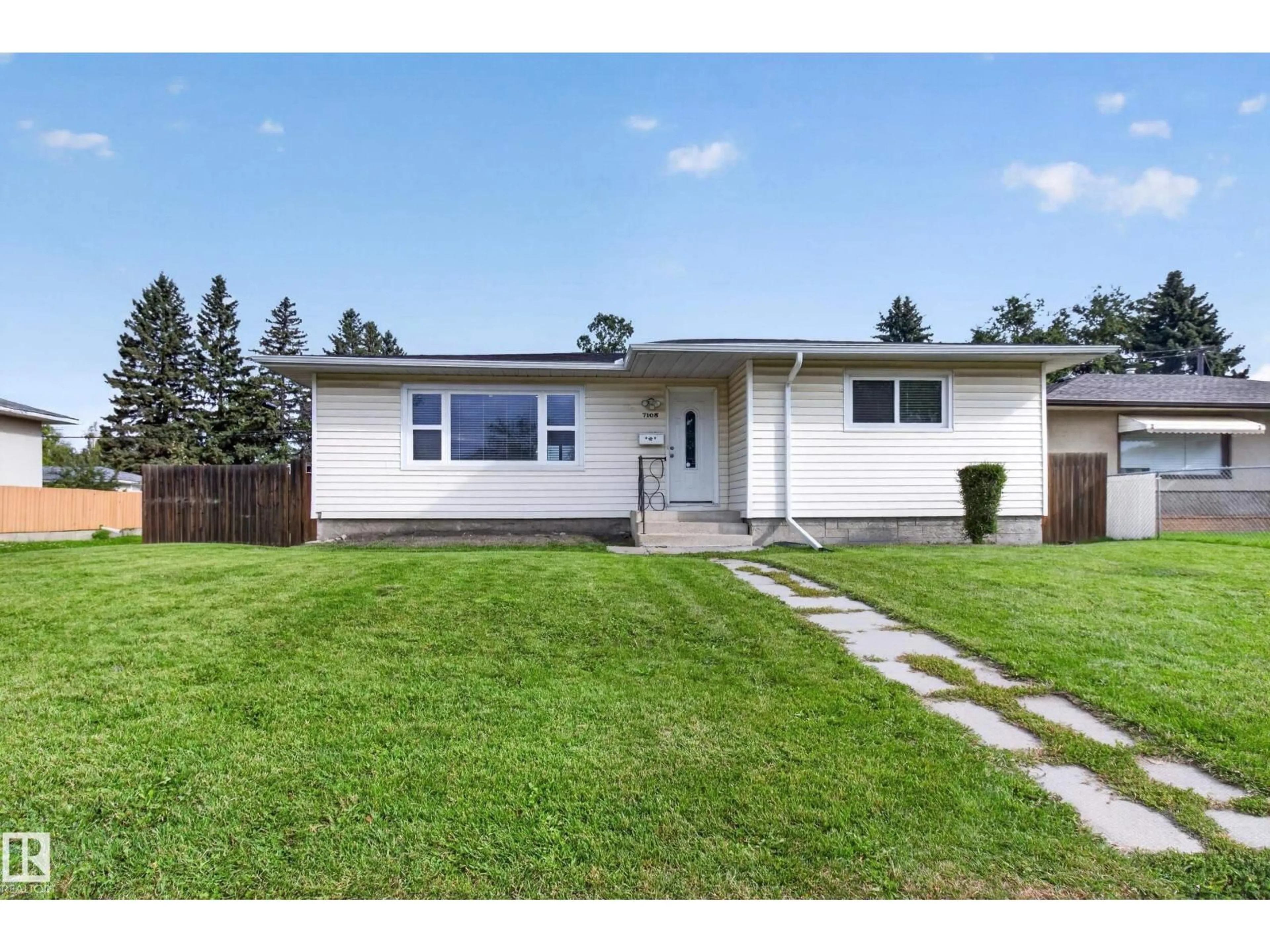 Home with vinyl exterior material, street for 7108 90 AV, Edmonton Alberta T6B0P4