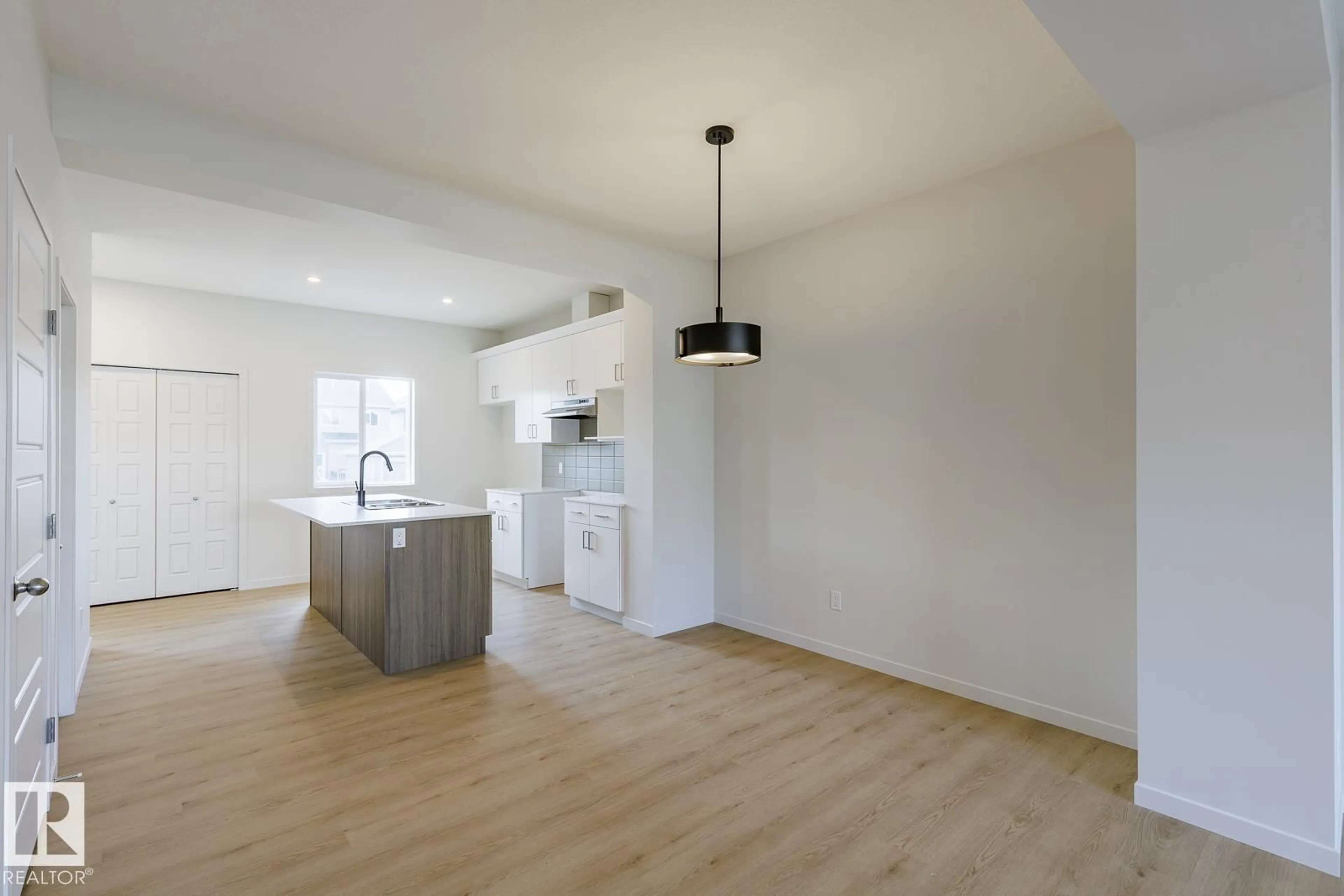Open concept kitchen, wood/laminate floor for 3617 TRIOMPHE BV, Beaumont Alberta T4X3A7