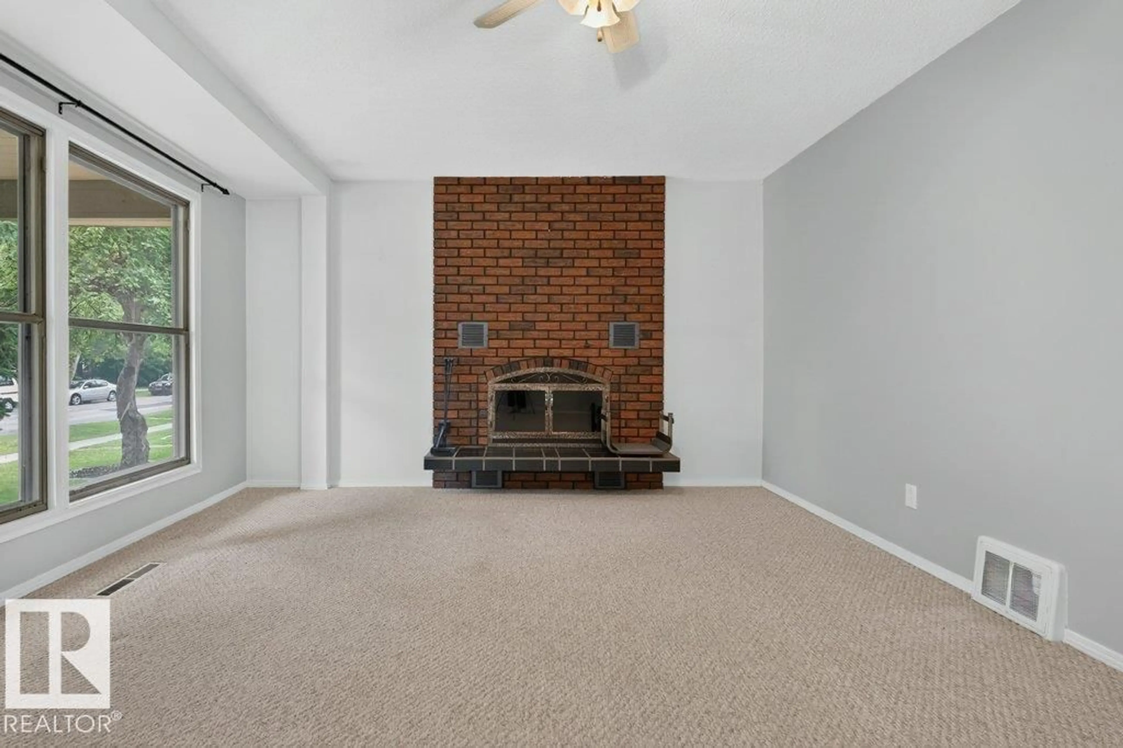 Living room with furniture, carpet floor for 9026 92 ST, Edmonton Alberta T6C3R2
