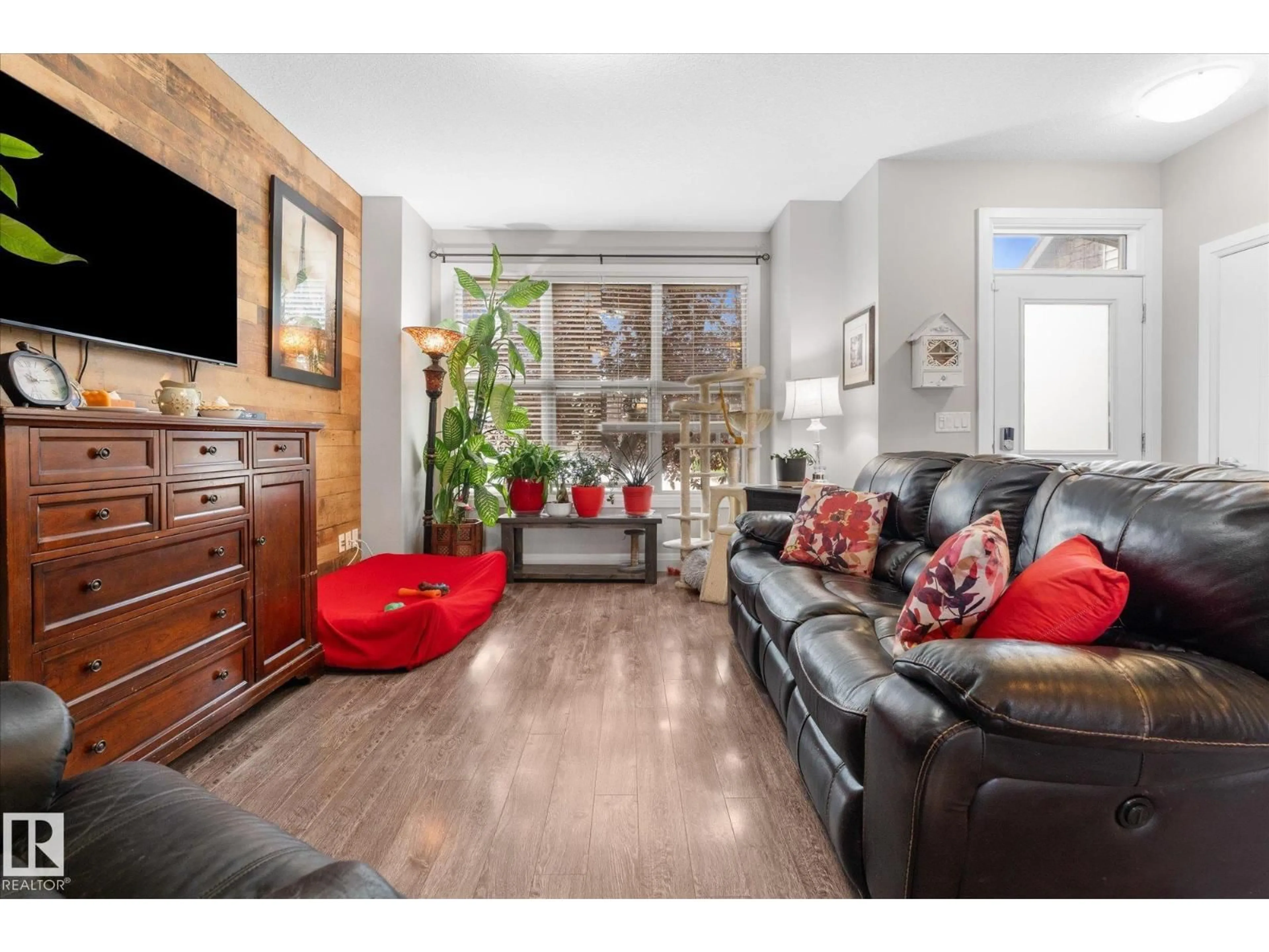 Living room with furniture, wood/laminate floor for 116 GILMORE WY, Spruce Grove Alberta T7X0M5