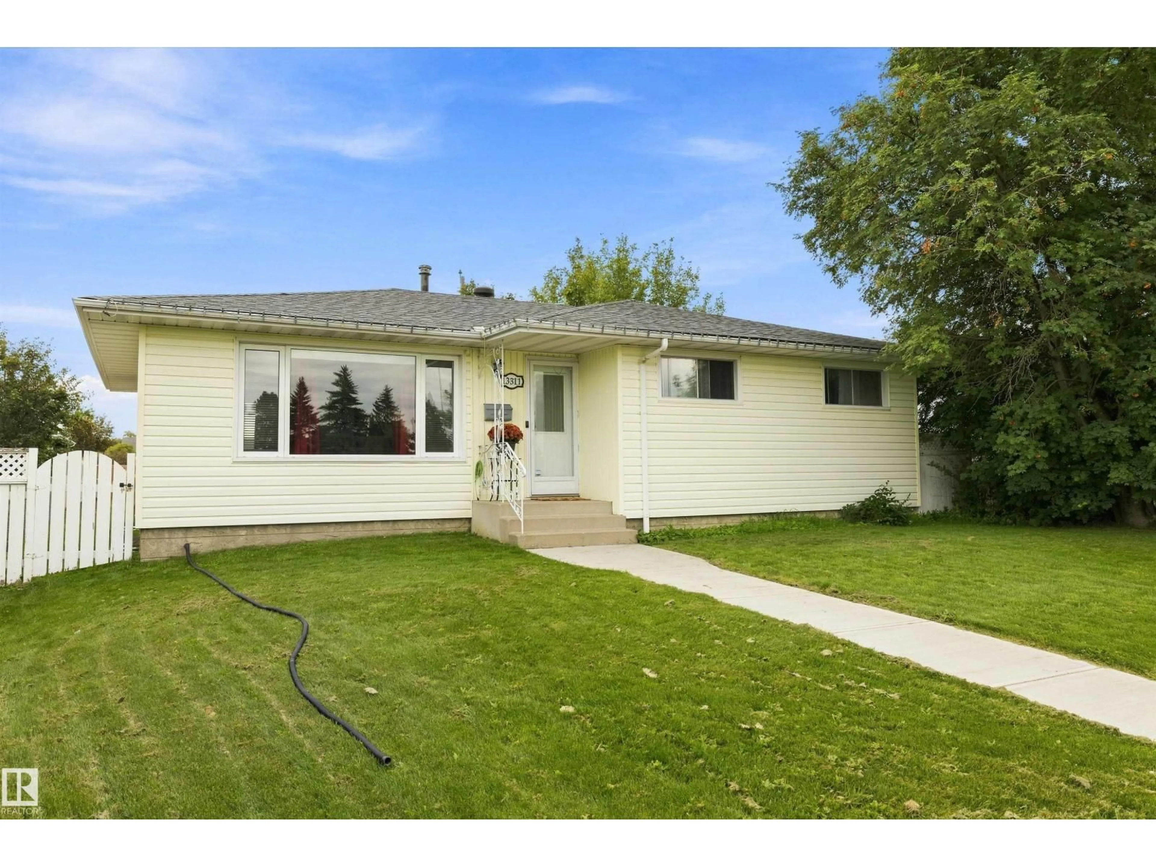 Home with vinyl exterior material, street for 13311 60 ST, Edmonton Alberta T5A0S4