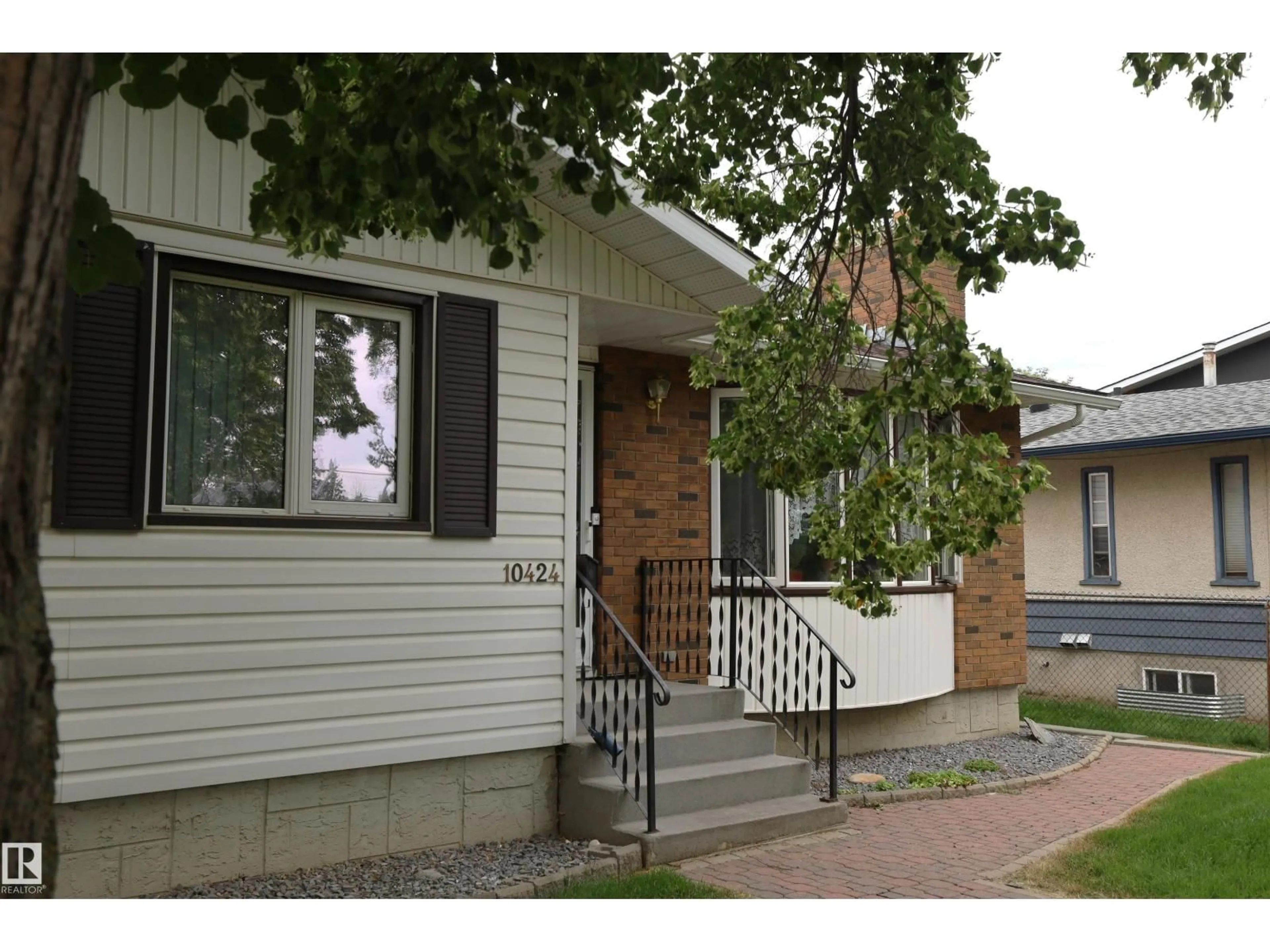 Home with vinyl exterior material, street for NW - 10424 152 ST, Edmonton Alberta T5P1Y6