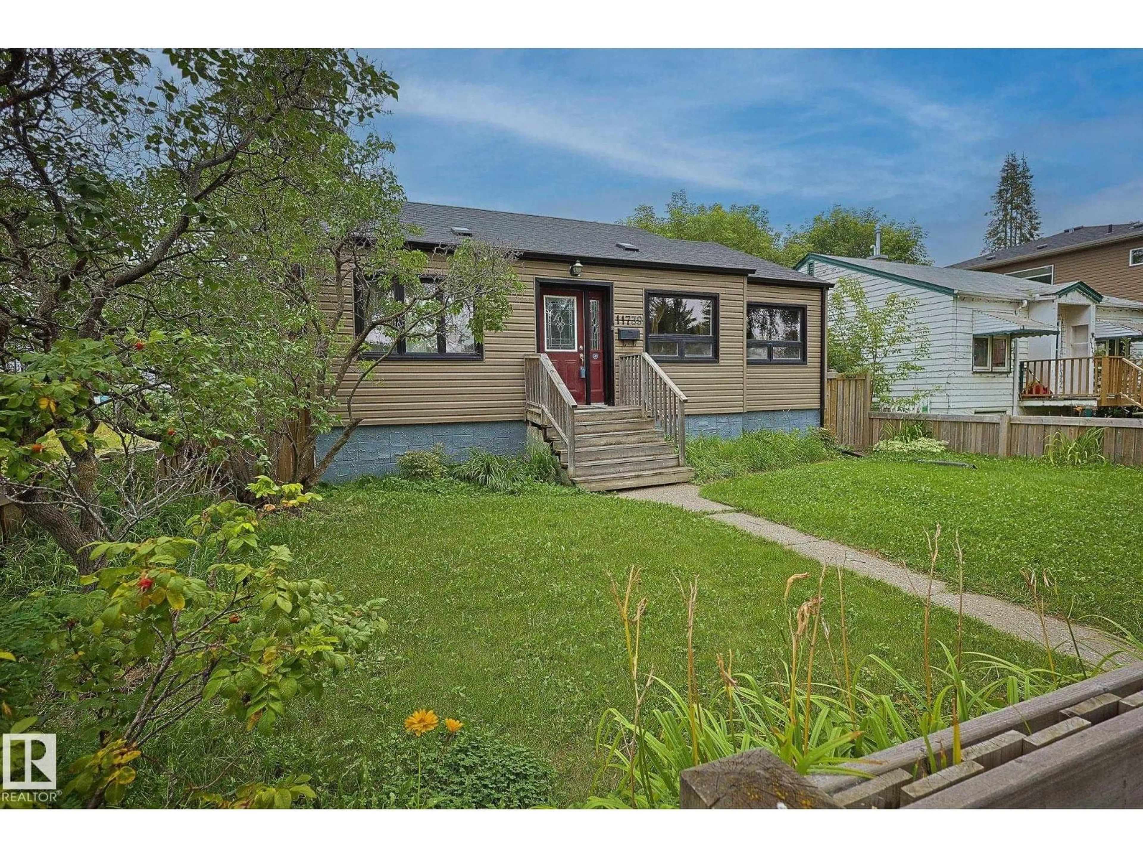 Home with vinyl exterior material, street for 11739 129 ST, Edmonton Alberta T5M0Y8
