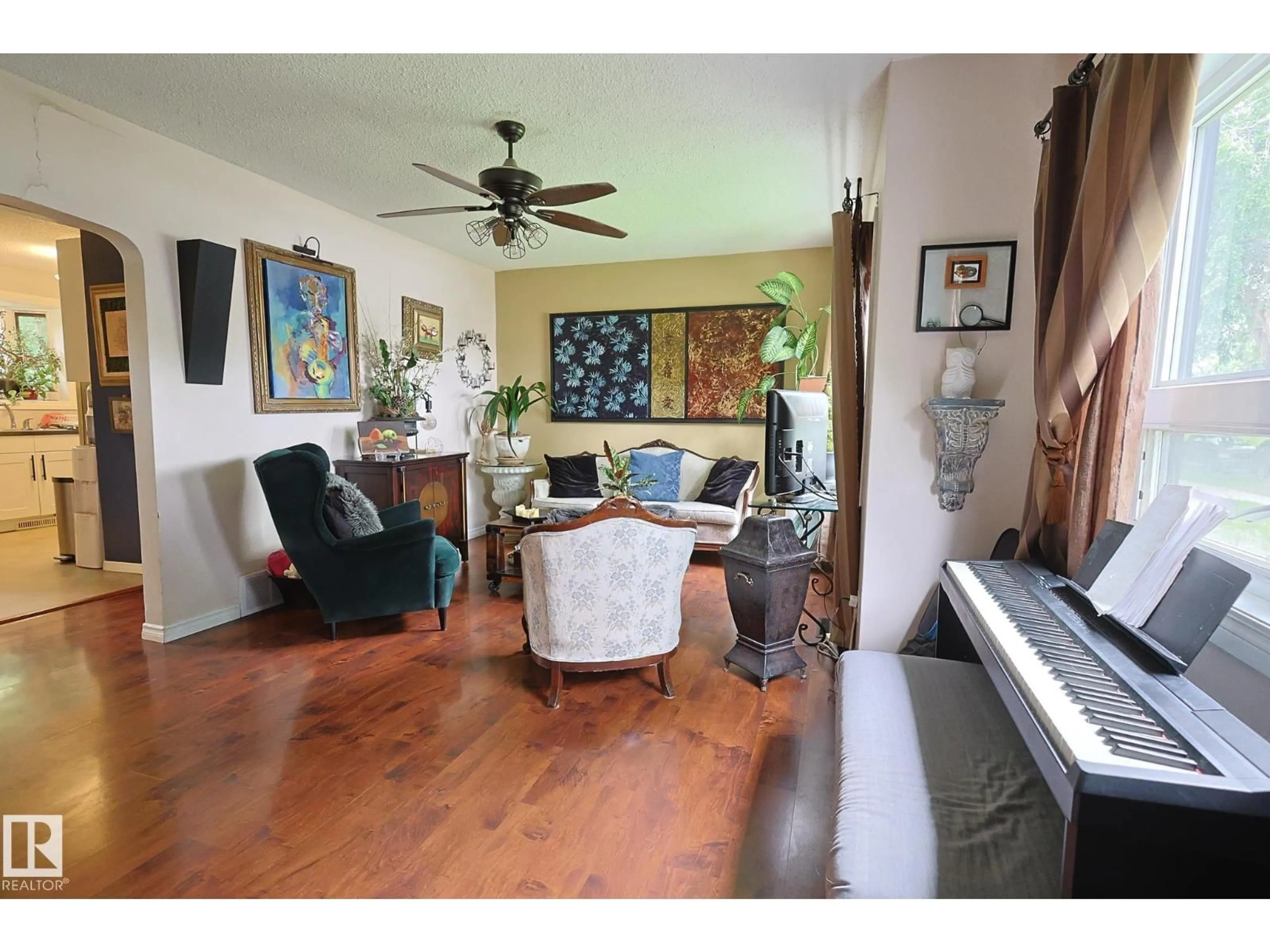 Living room with furniture, wood/laminate floor for 11739 129 ST, Edmonton Alberta T5M0Y8