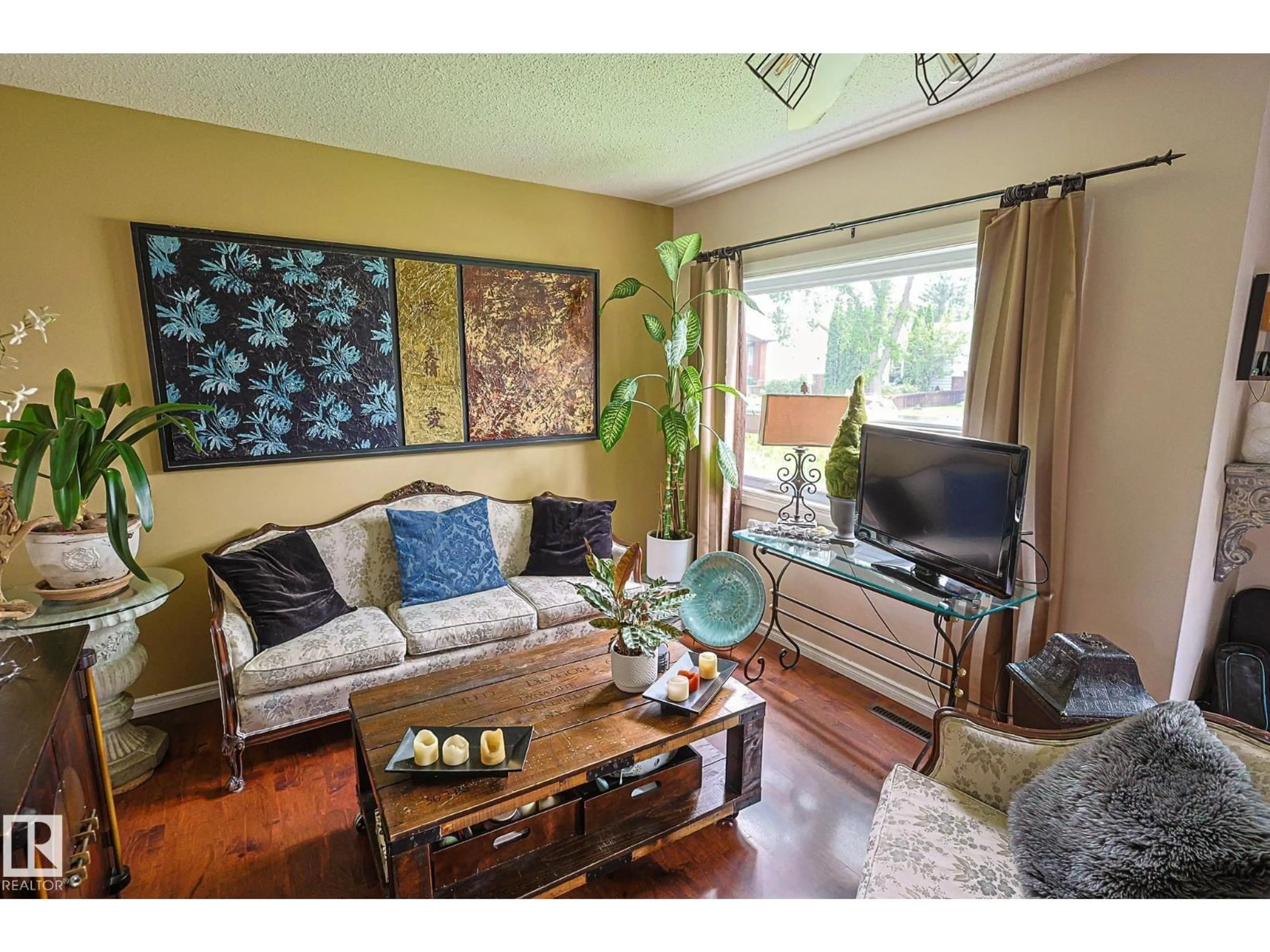 Living room with furniture, wood/laminate floor for 11739 129 ST, Edmonton Alberta T5M0Y8