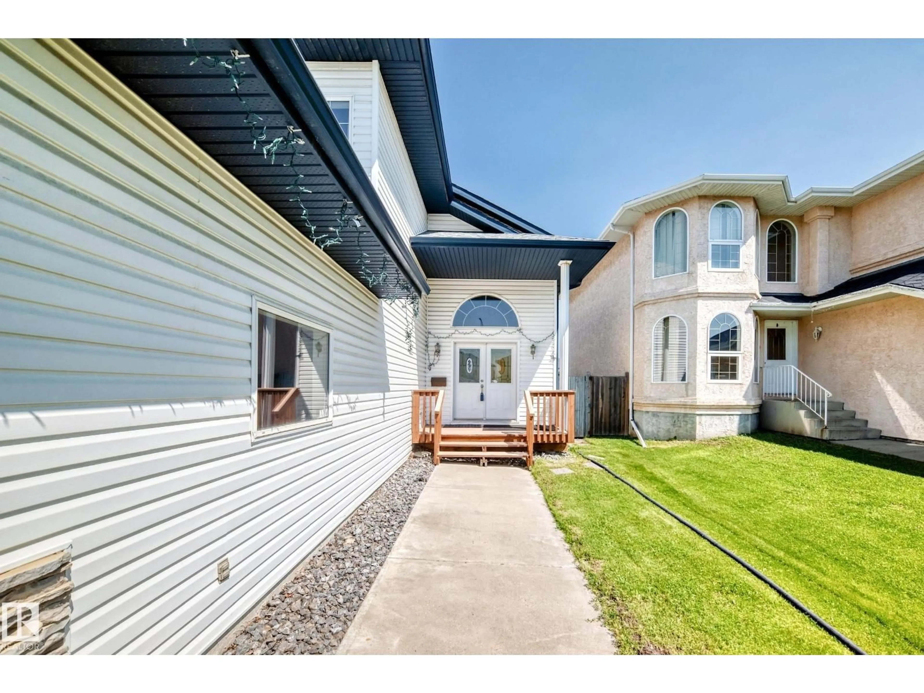 Home with vinyl exterior material, street for NW - 16227 64 ST, Edmonton Alberta T5Y3E2