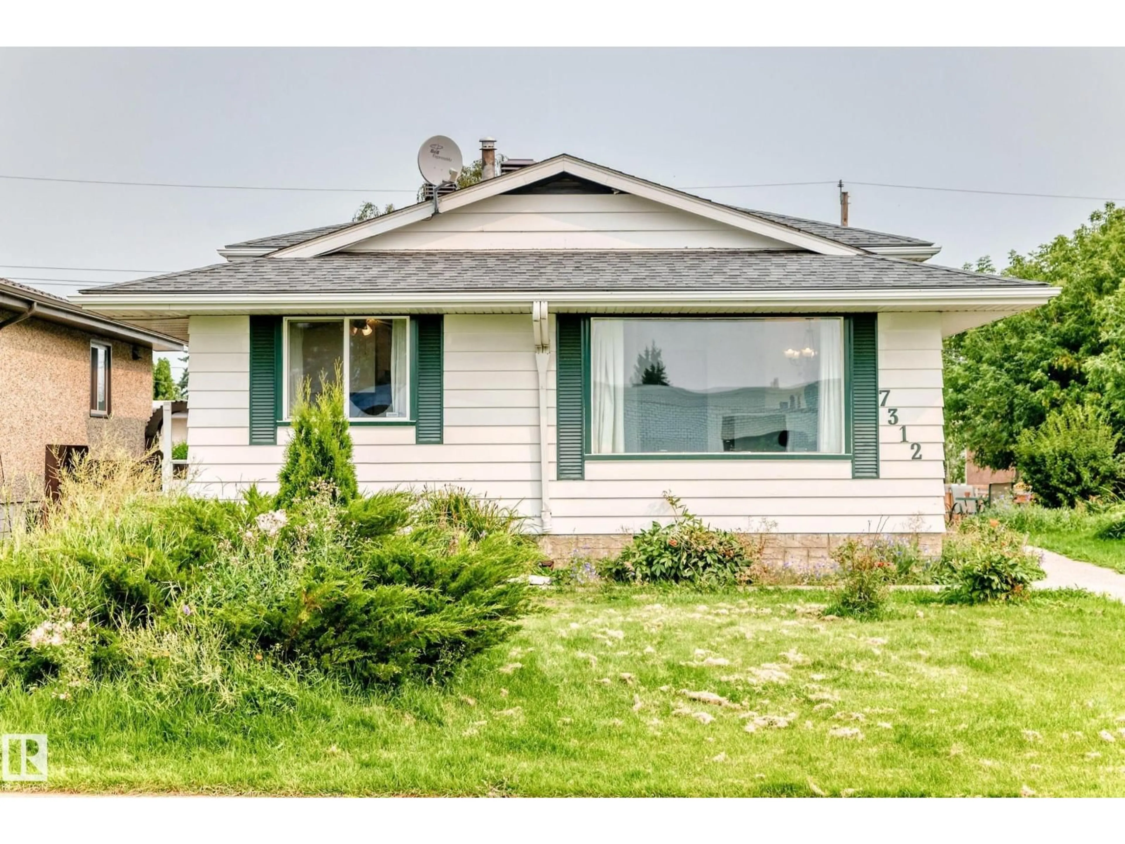 Home with vinyl exterior material, street for 7312 DELWOOD RD, Edmonton Alberta T5C3A7
