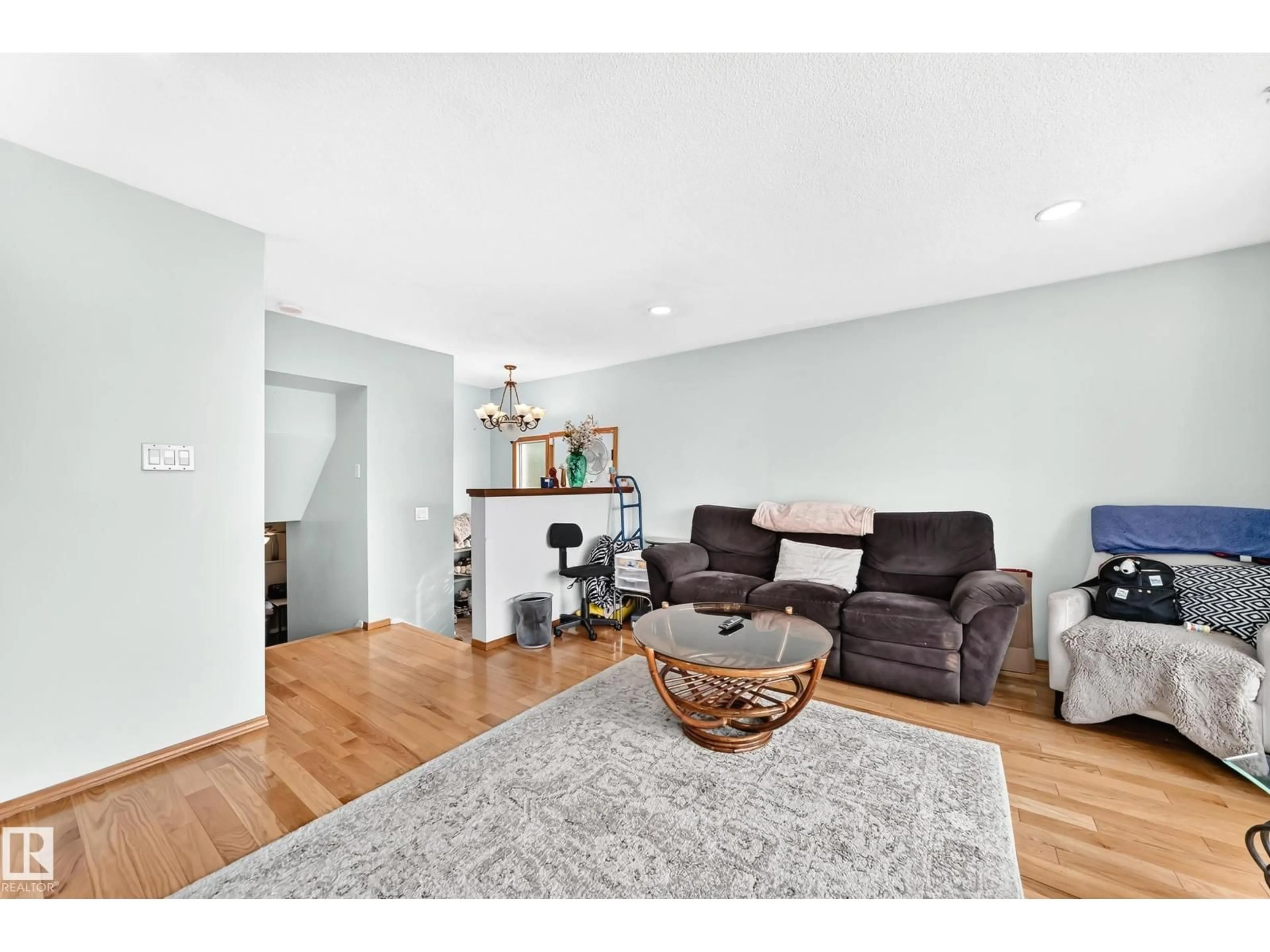 Living room with furniture, wood/laminate floor for 7312 DELWOOD RD, Edmonton Alberta T5C3A7