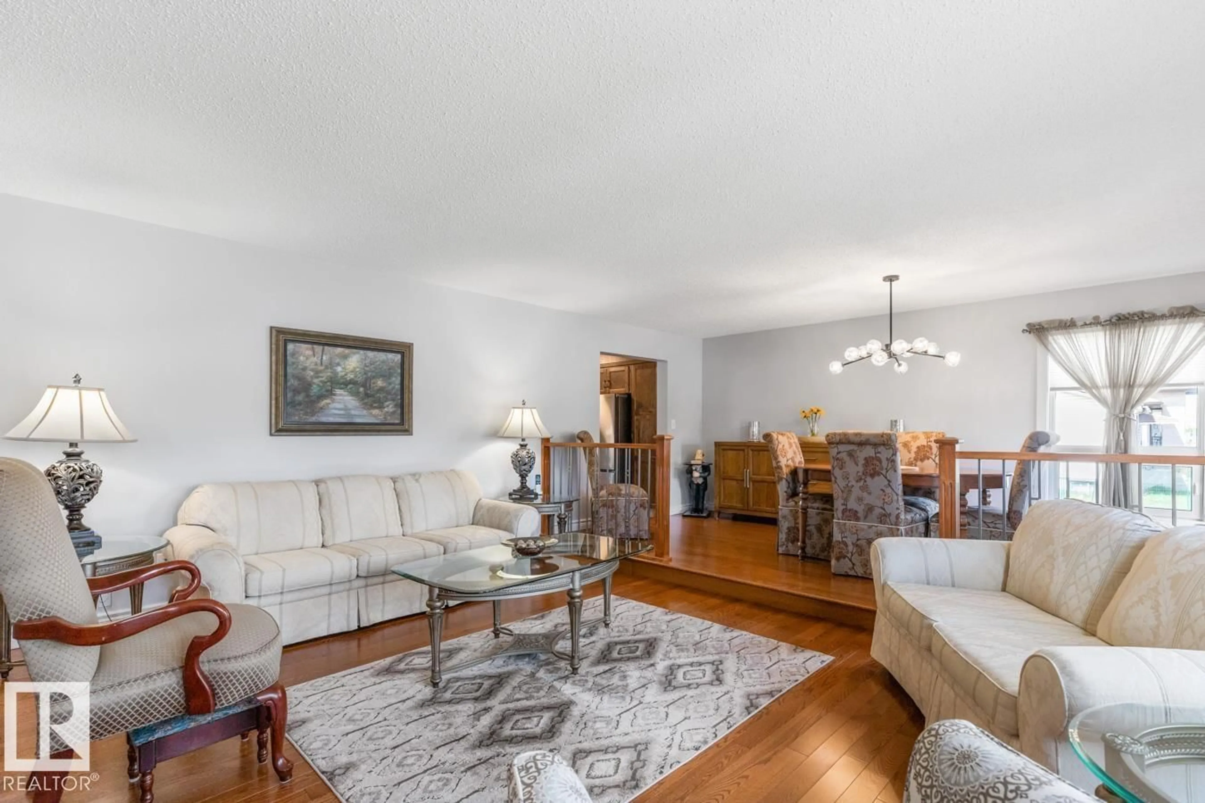 Living room with furniture, wood/laminate floor for NW - 10502 158 ST, Edmonton Alberta T5P2Y6