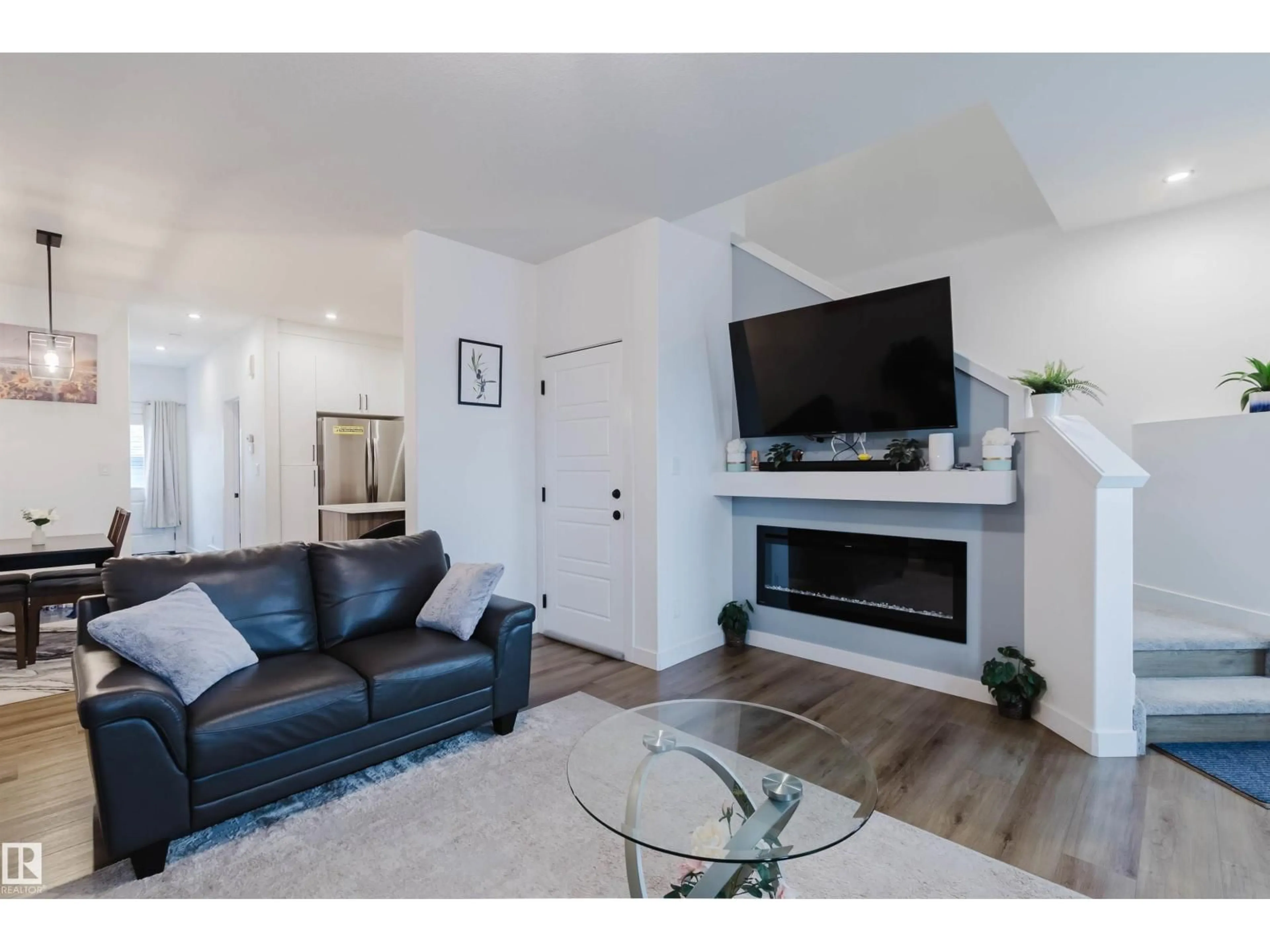 Living room with furniture, wood/laminate floor for 104 MEADOWVIEW WAY, Leduc Alberta T9E1R6