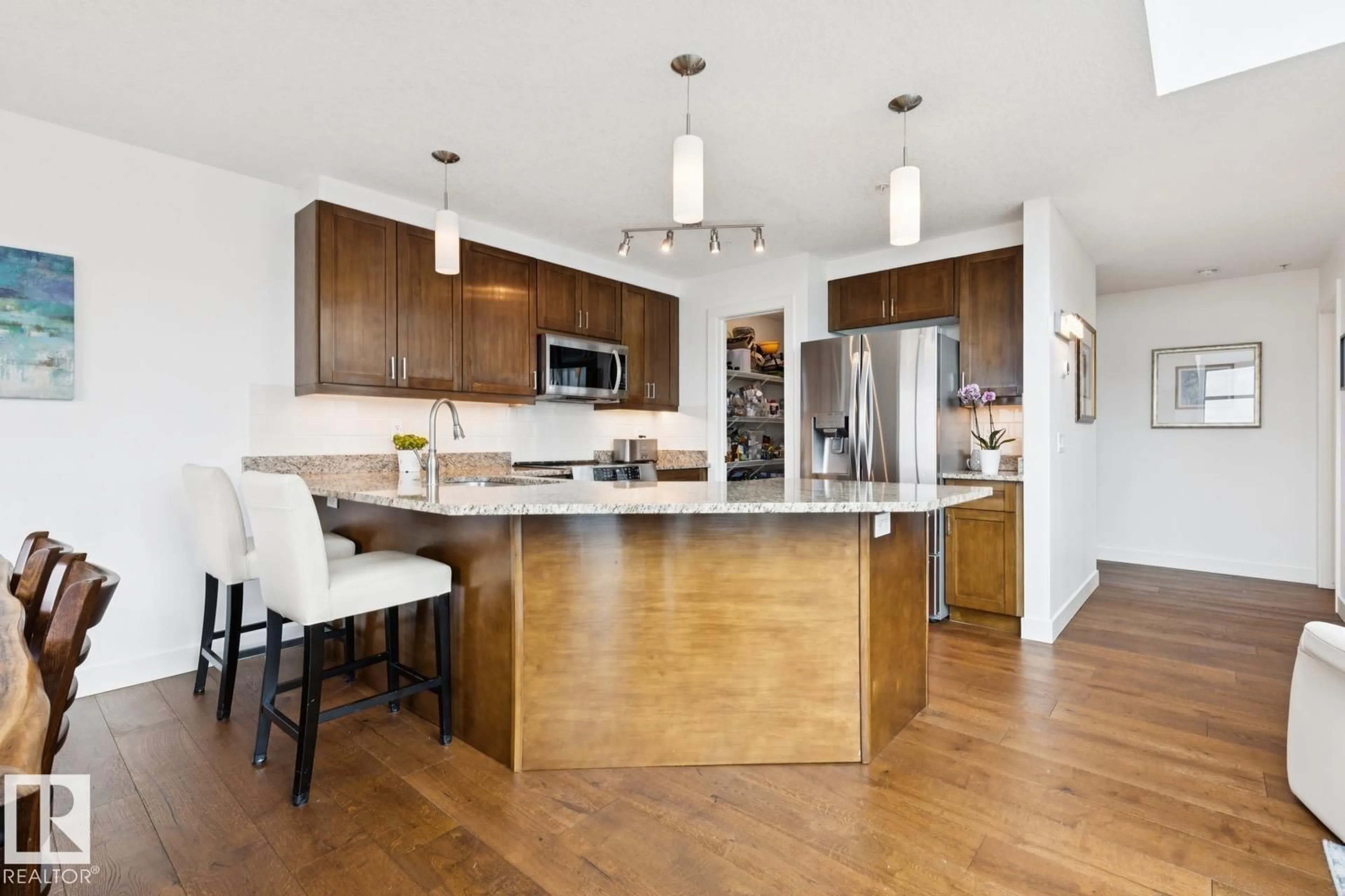 Open concept kitchen, wood/laminate floor for 506 - 1238 WINDERMERE WY, Edmonton Alberta T6W2J3