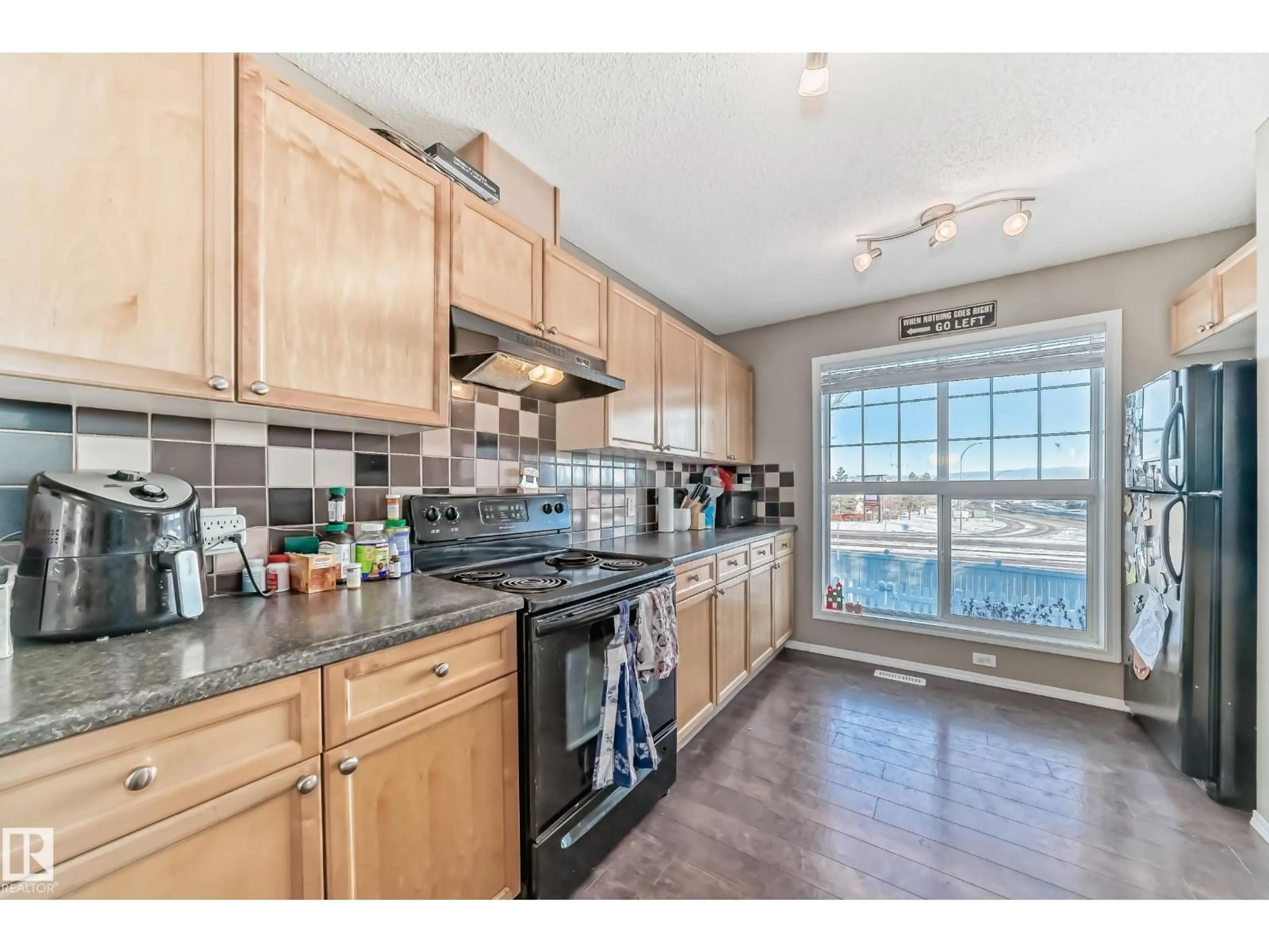 Open concept kitchen, wood/laminate floor for 119 - 5604 199 ST, Edmonton Alberta T6M2Z9