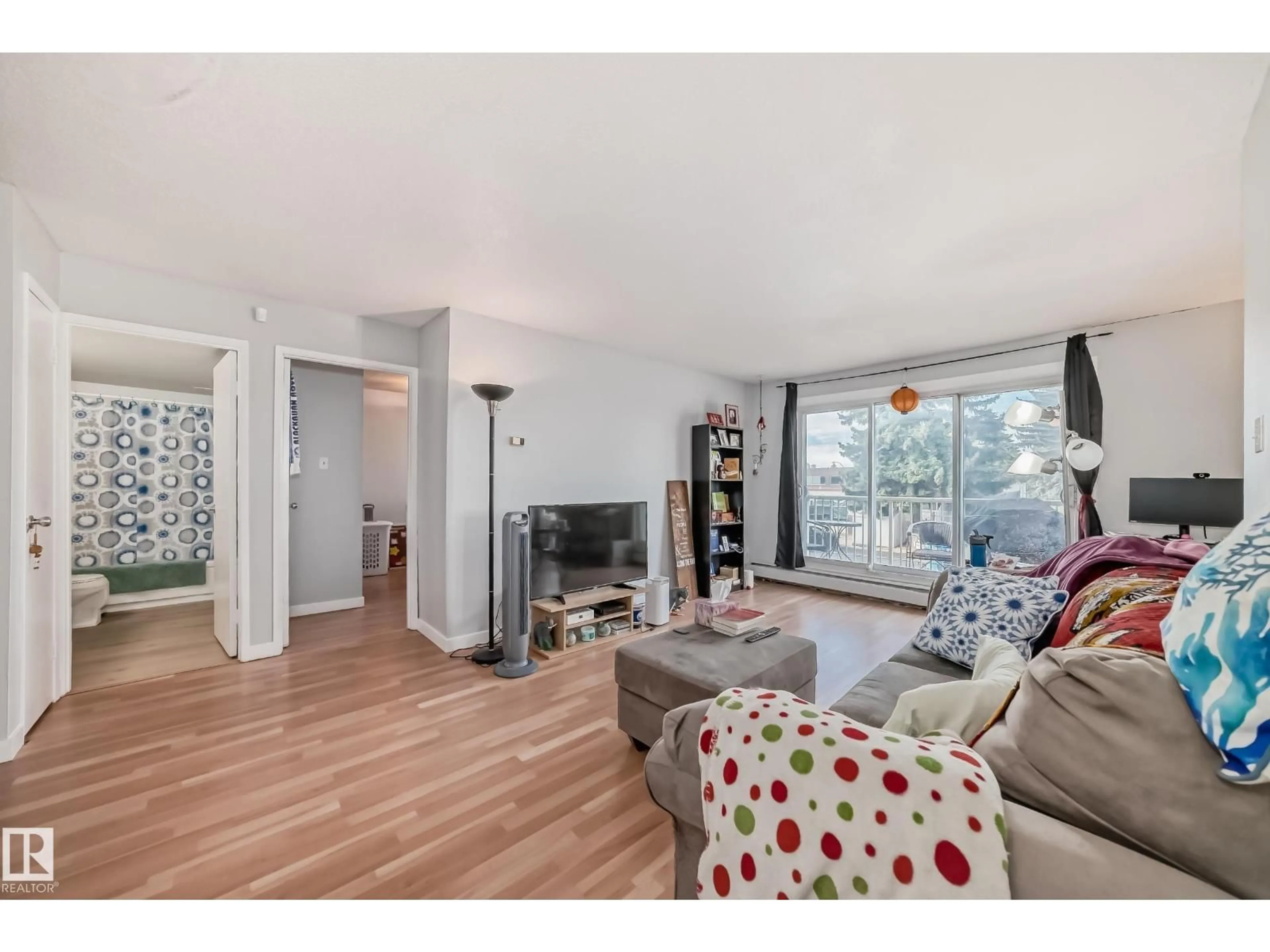 Living room with furniture, wood/laminate floor for 206 - 7220 144 AV, Edmonton Alberta T5C3E4