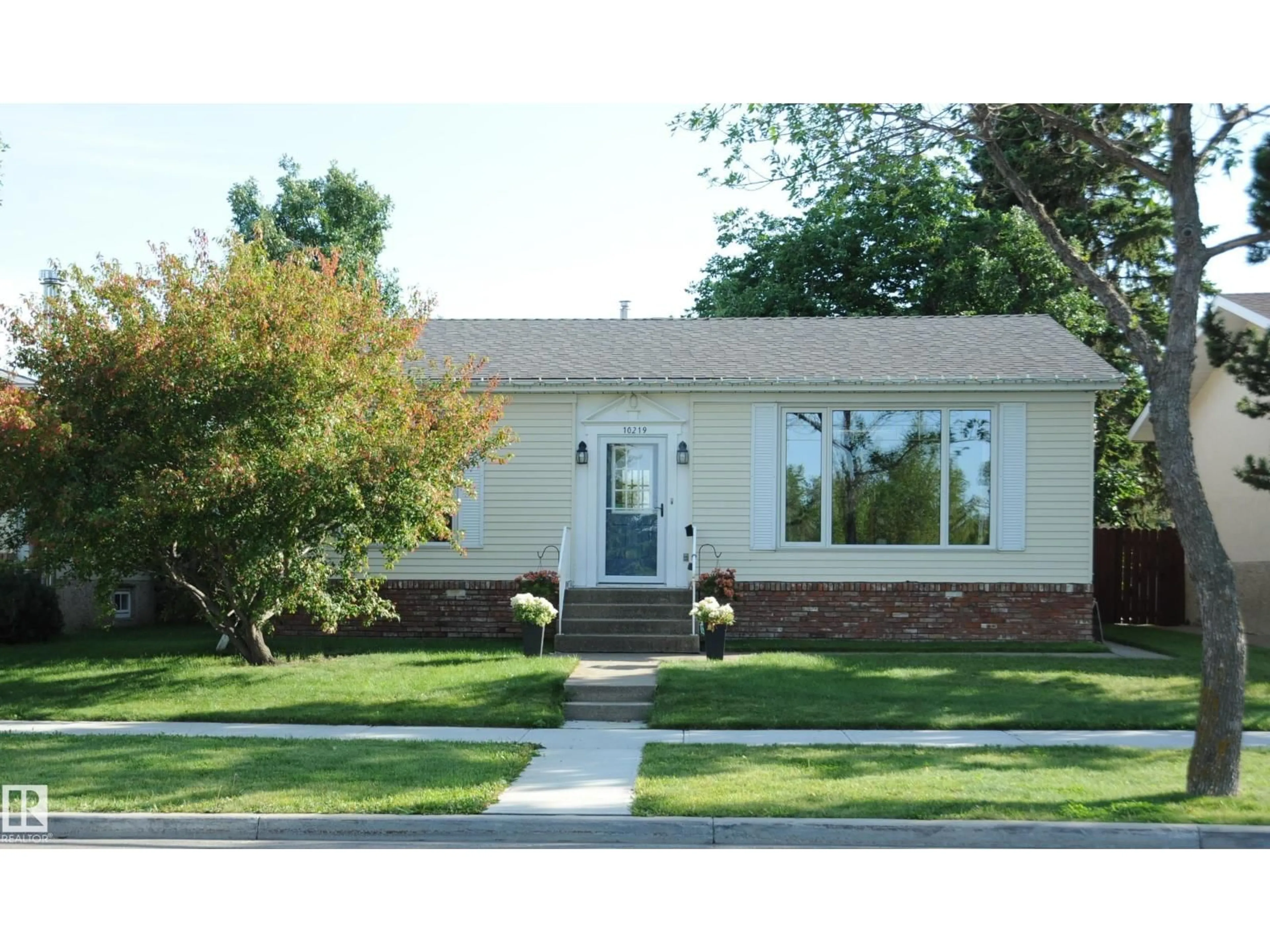 Home with vinyl exterior material, street for 10219 155 AV NW, Edmonton Alberta T5X4G4