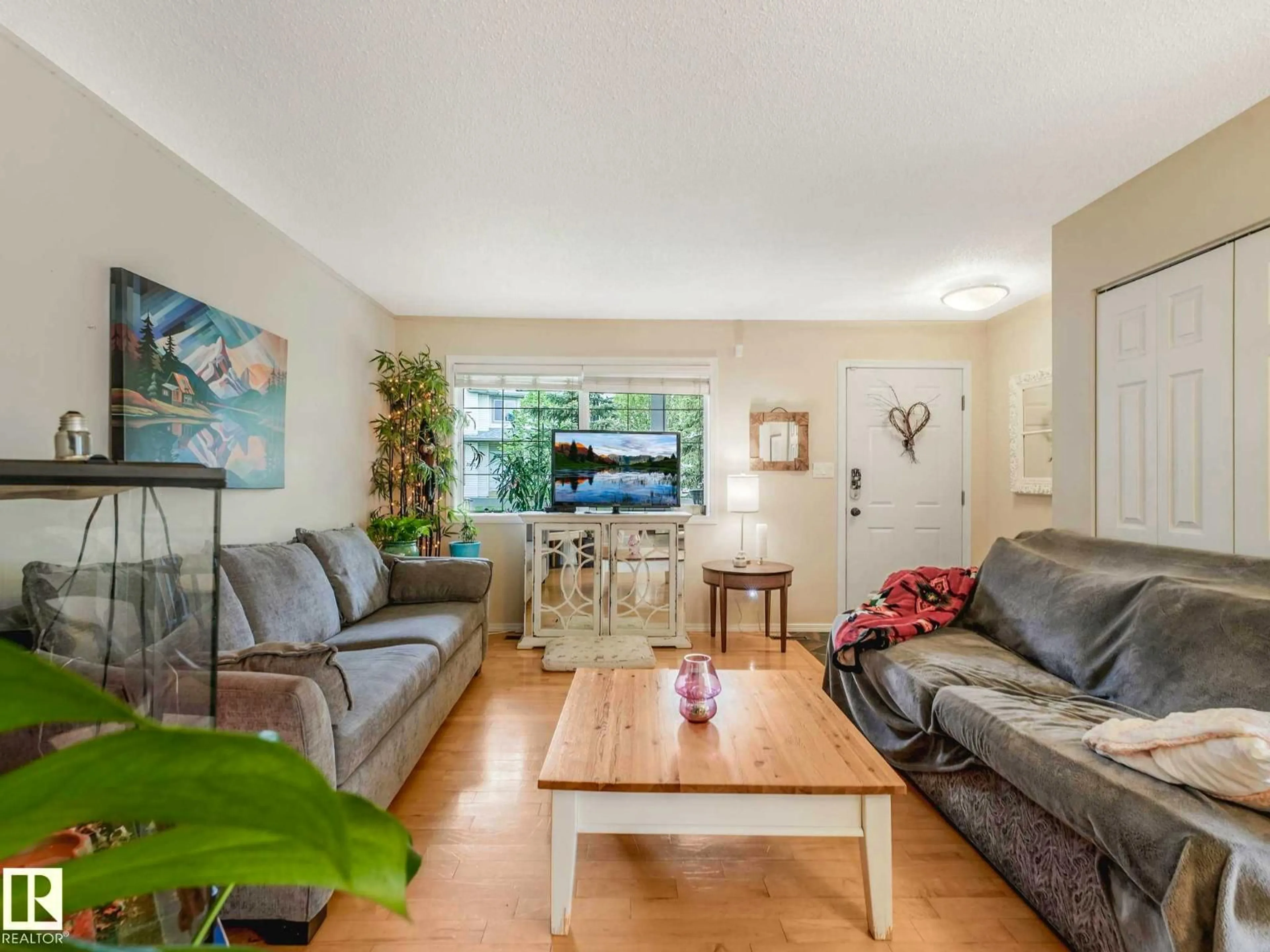 Living room with furniture, wood/laminate floor for 4031 38 STREET NW, Edmonton Alberta T6L6W8