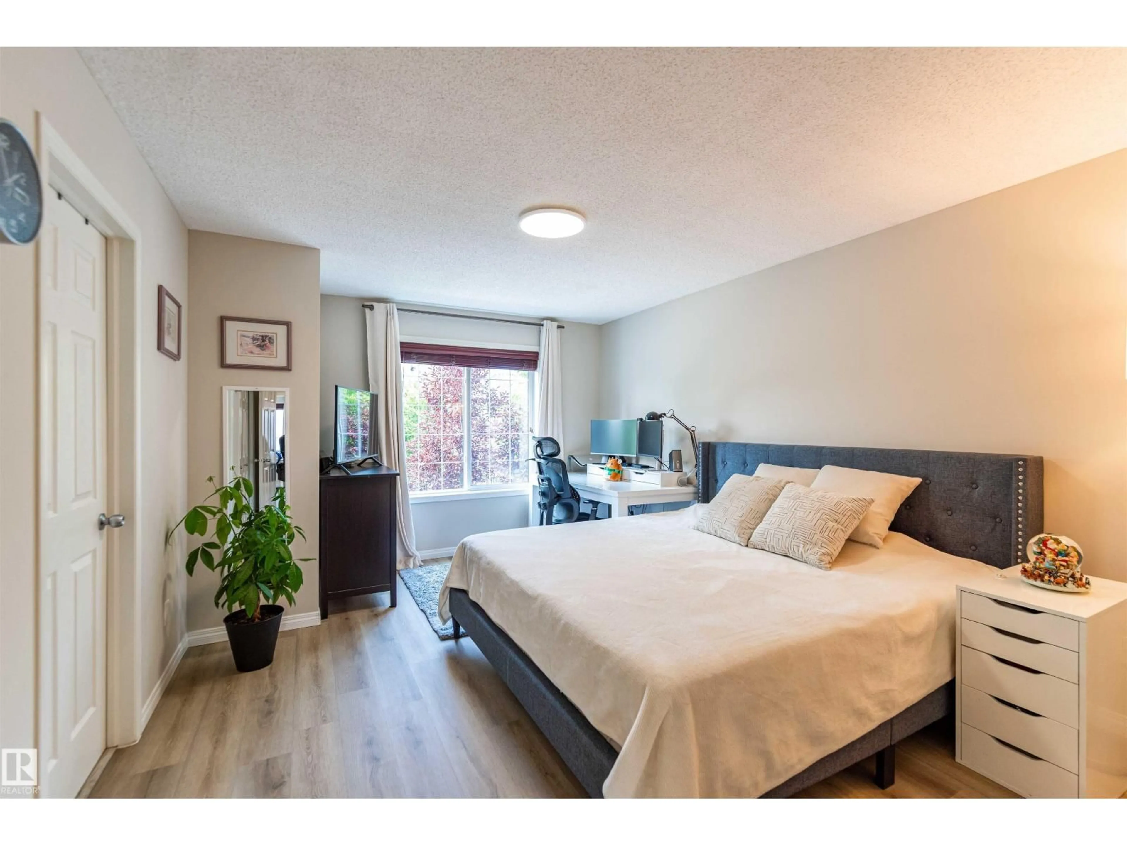 Bedroom with bed, wood/laminate floor for 8527 ELLIS LINK NW, Edmonton Alberta T6M0P5