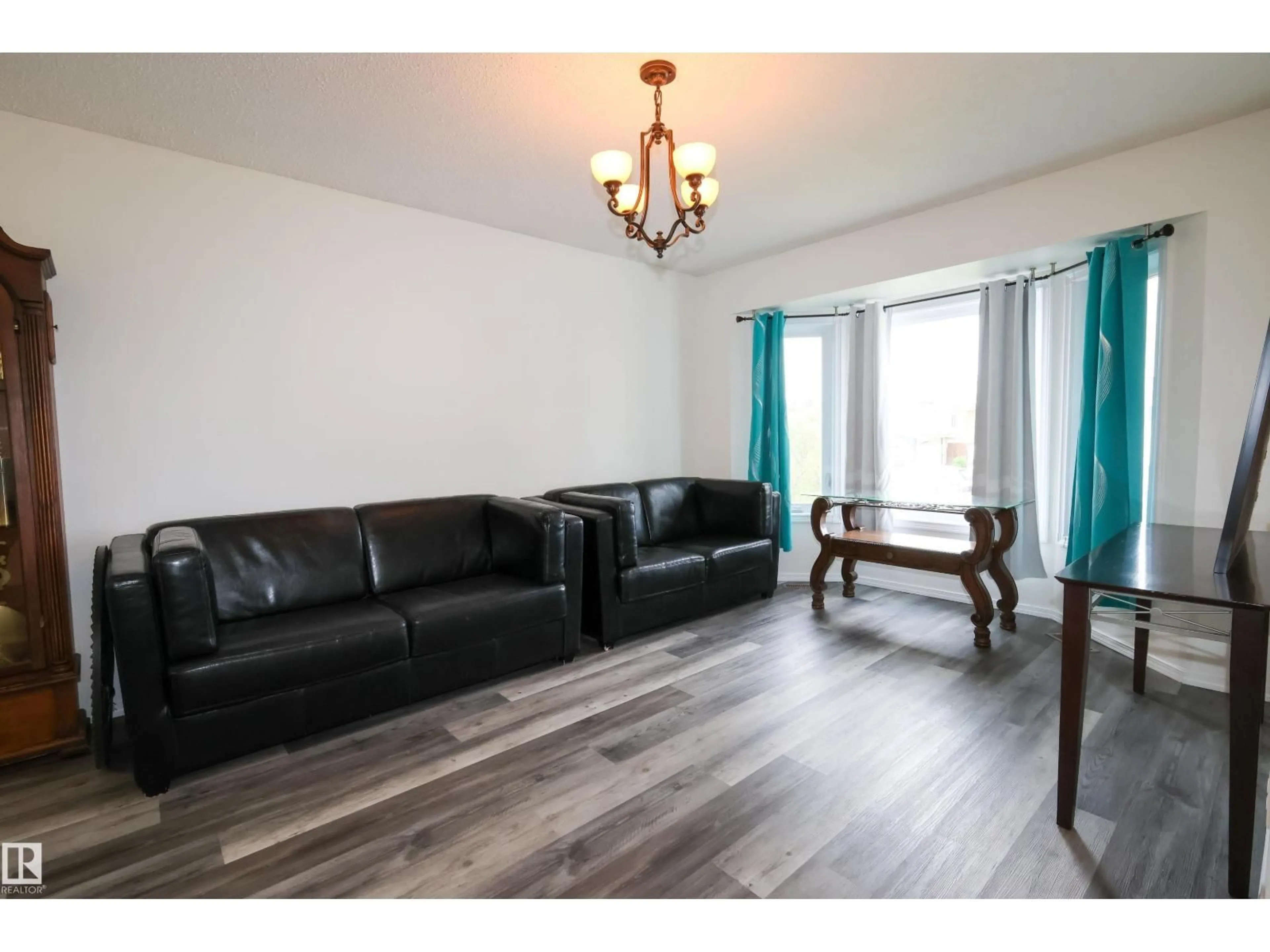 Living room with furniture, wood/laminate floor for NW - 3467 39 ST, Edmonton Alberta T6L3Y9
