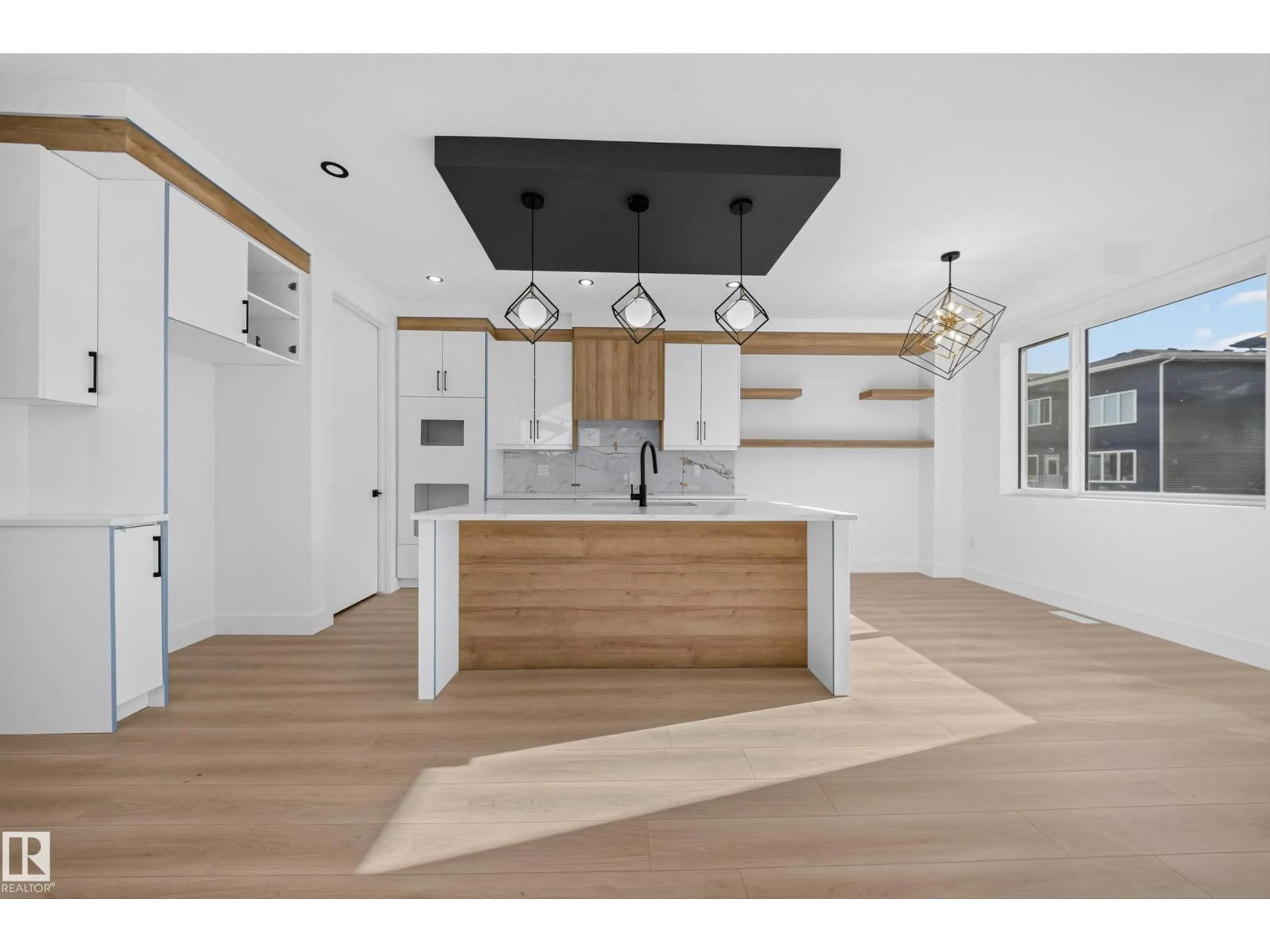 Open concept kitchen, wood/laminate floor for 6706 176A AV, Edmonton Alberta T5Z0Y2