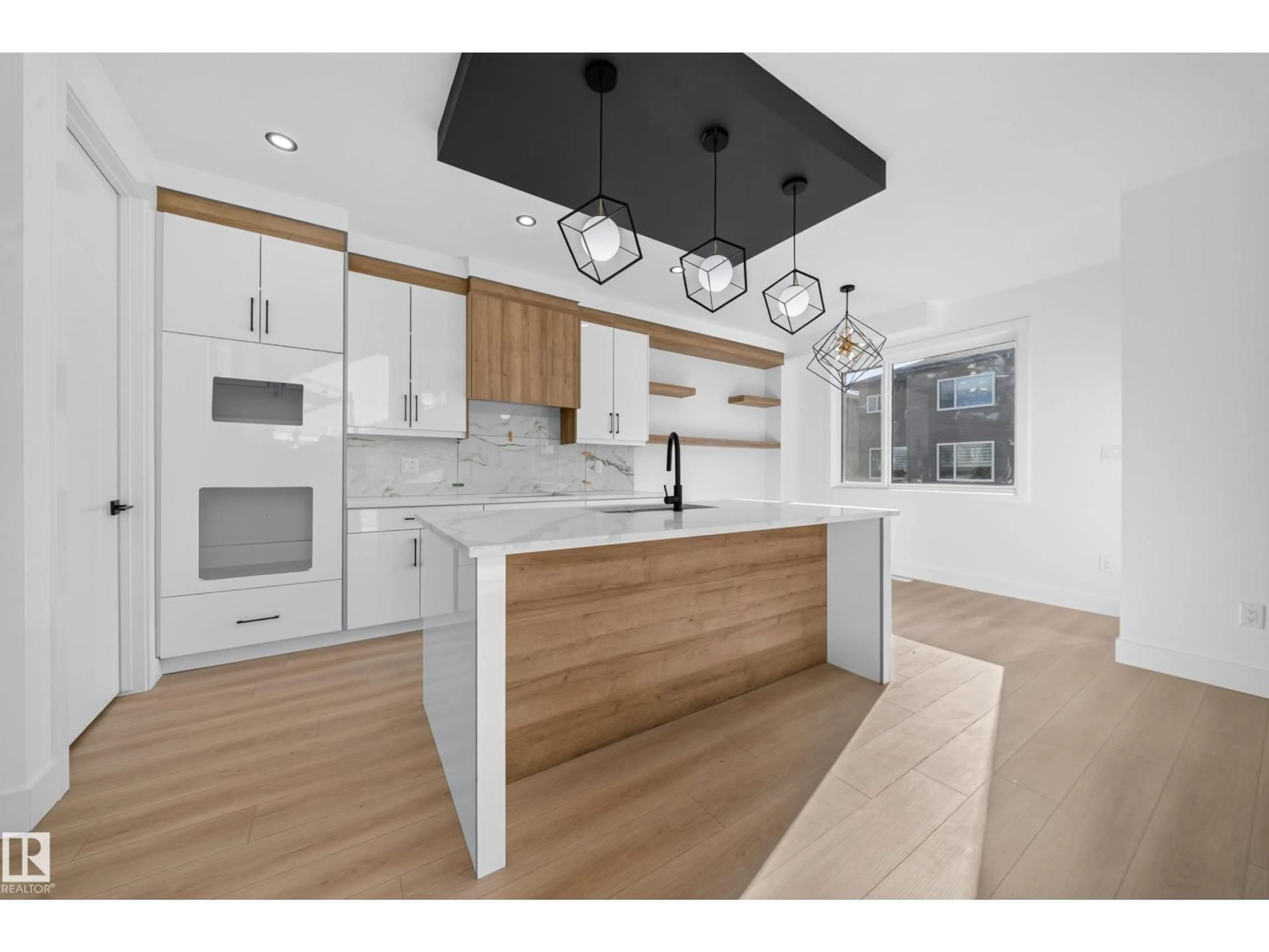 Open concept kitchen, wood/laminate floor for 6706 176A AV, Edmonton Alberta T5Z0Y2