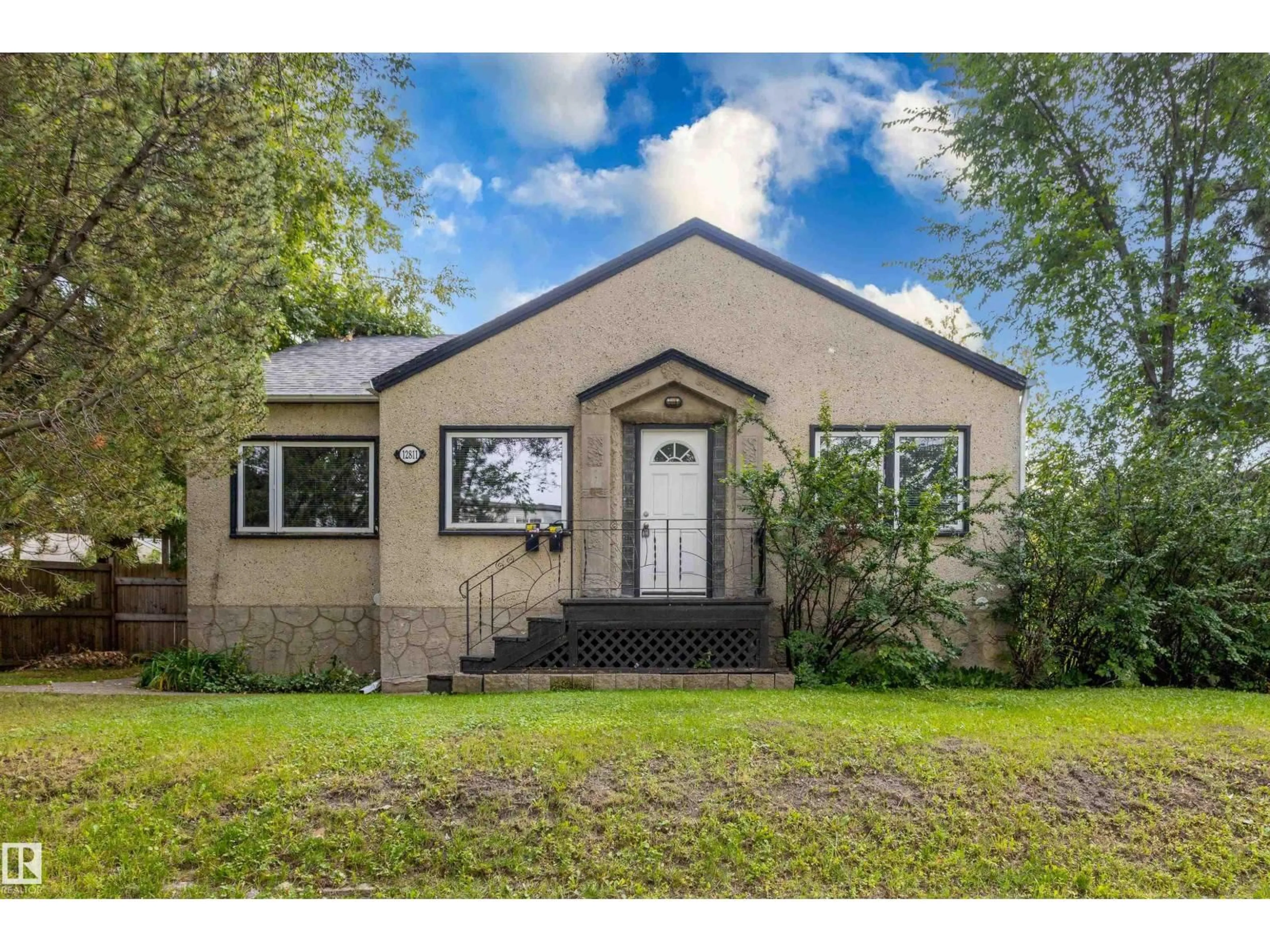 Home with vinyl exterior material, street for 12811 117 AV, Edmonton Alberta T5M3H2