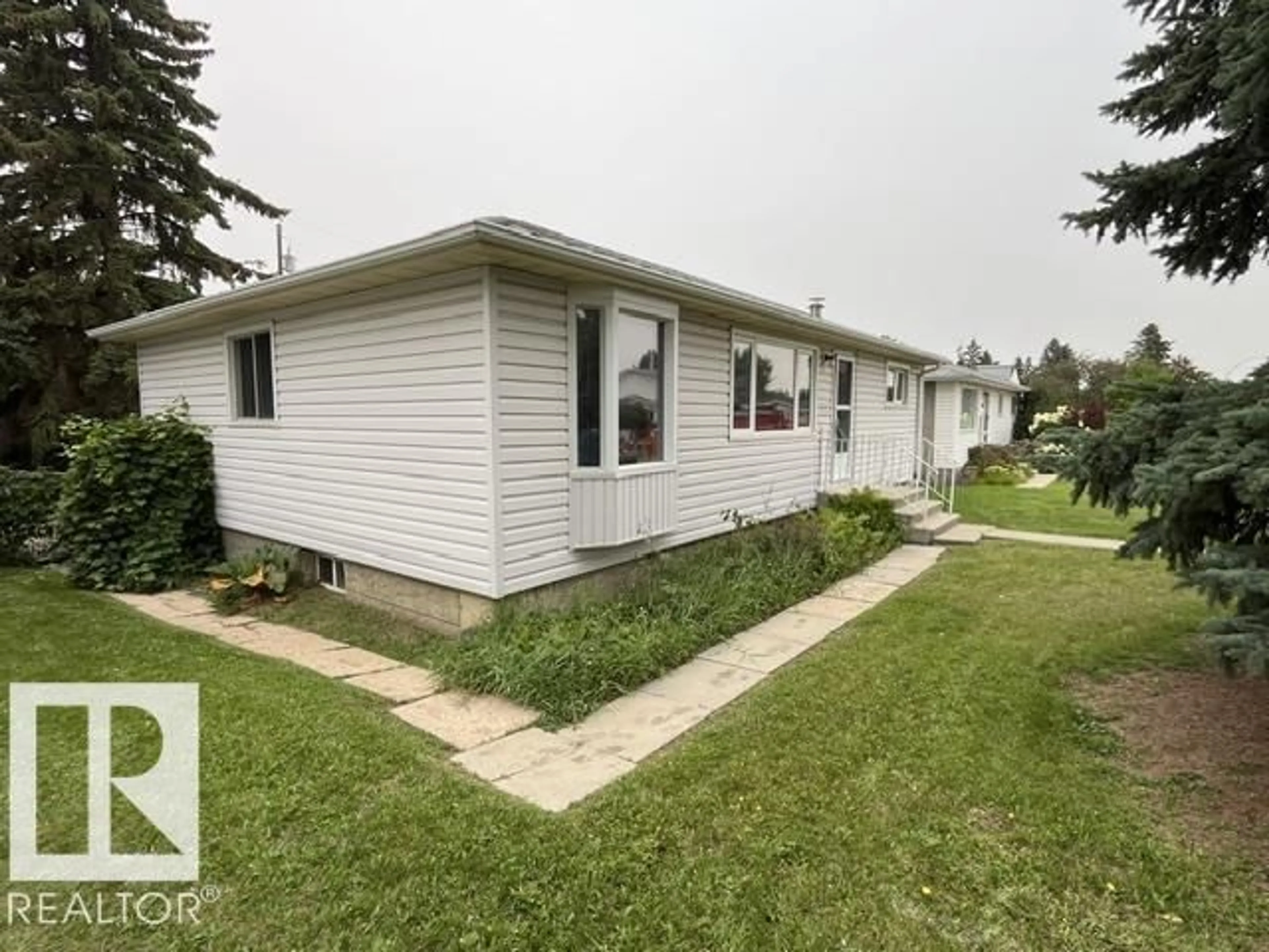 Home with vinyl exterior material, street for NW - 10332 47 ST, Edmonton Alberta T6A1Z7