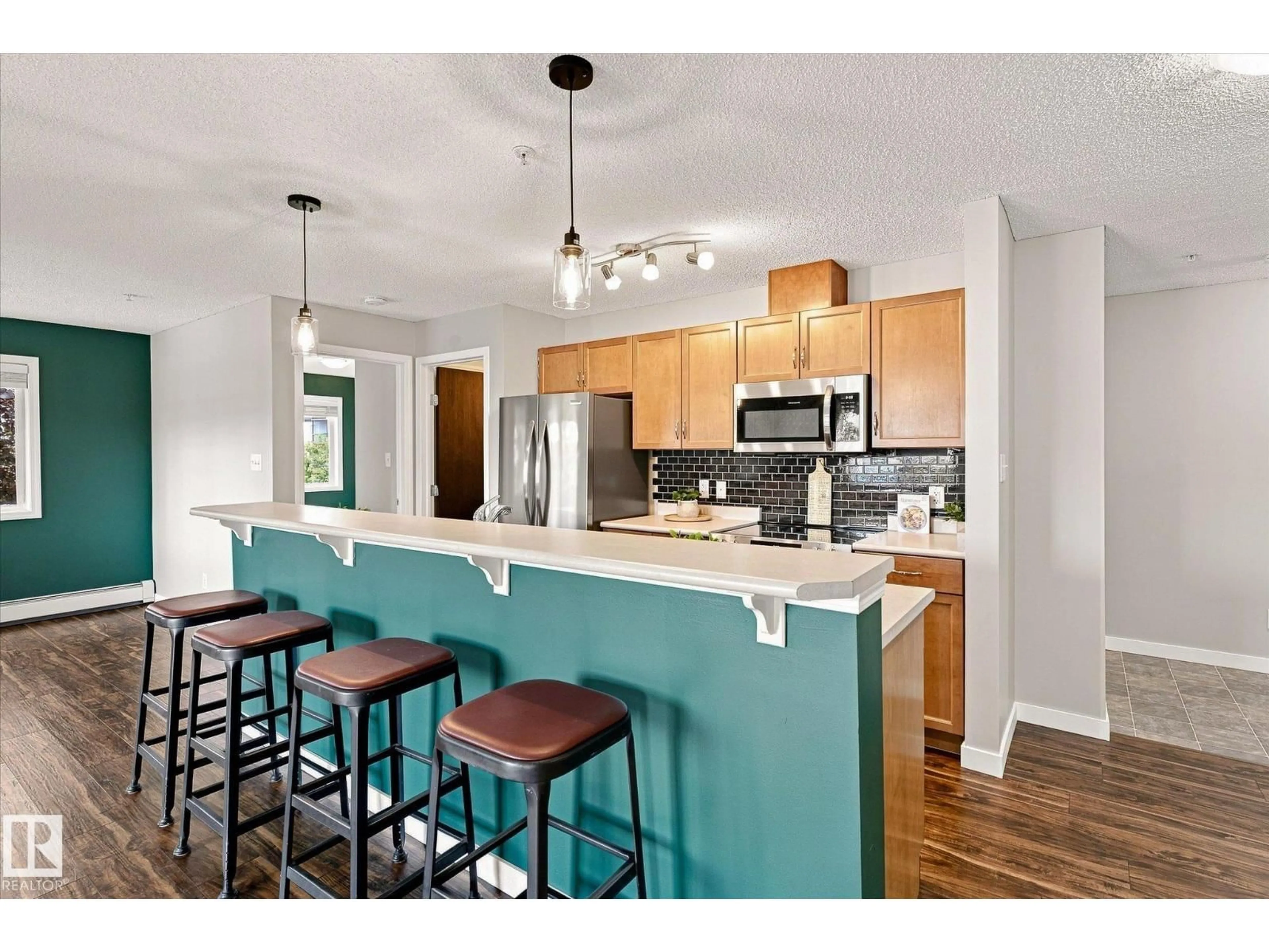 Open concept kitchen, wood/laminate floor for 1180 - 240 HYNDMAN RD, Edmonton Alberta T5A0P8