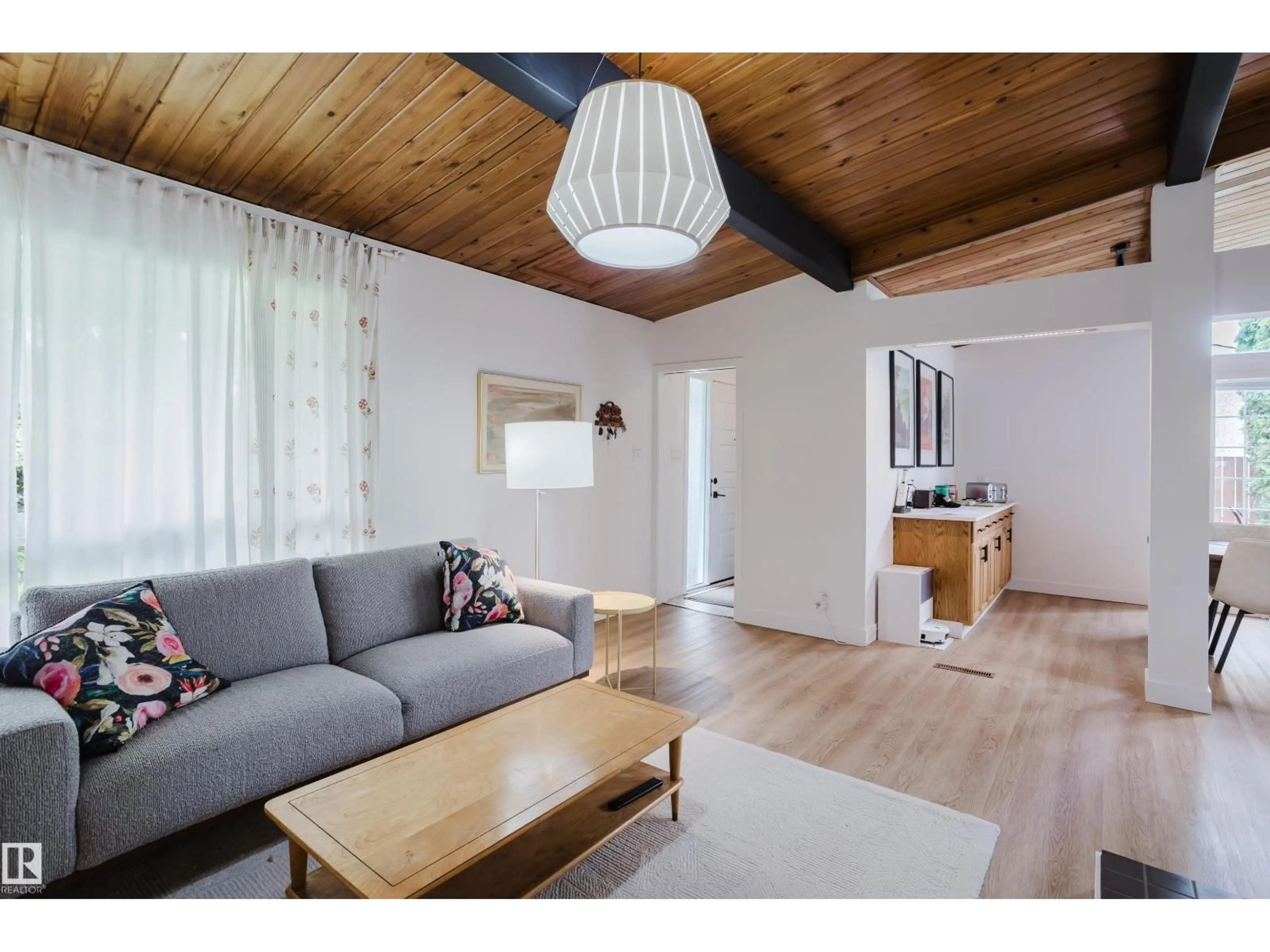 Living room with furniture, wood/laminate floor for 9059 52 ST, Edmonton Alberta T6B1G1