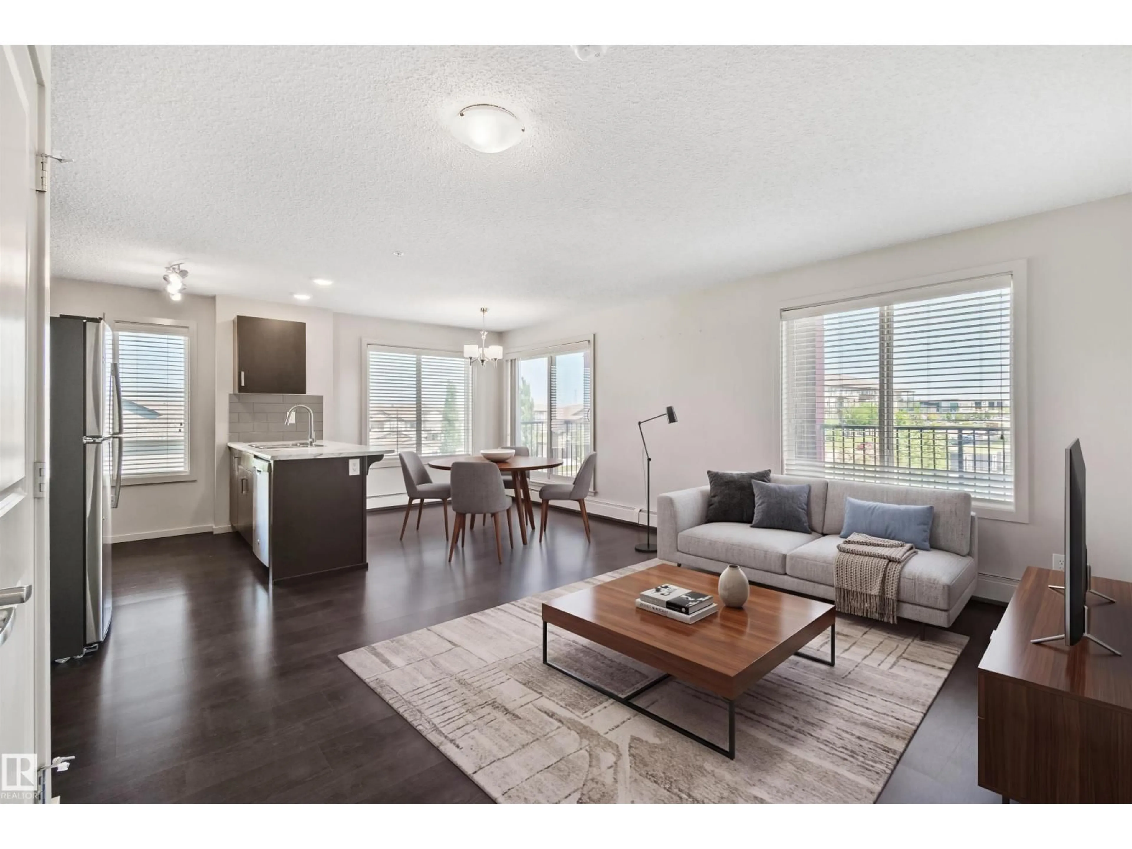 Living room with furniture, wood/laminate floor for 318 - 5521 7 AV SW, Edmonton Alberta T6X2A8