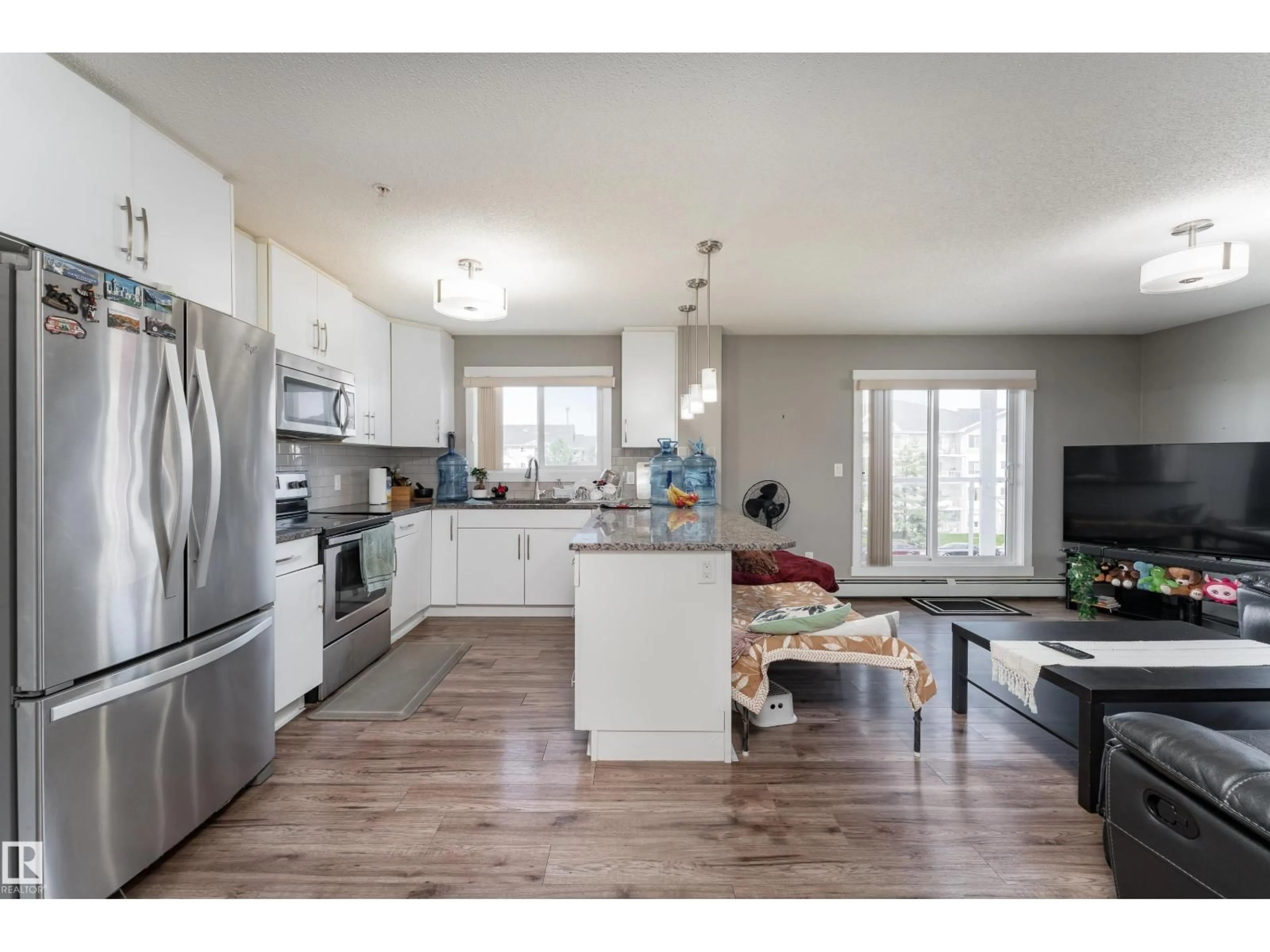 Open concept kitchen, wood/laminate floor for #302 - 2229 44 AV NW, Edmonton Alberta T6T0W6