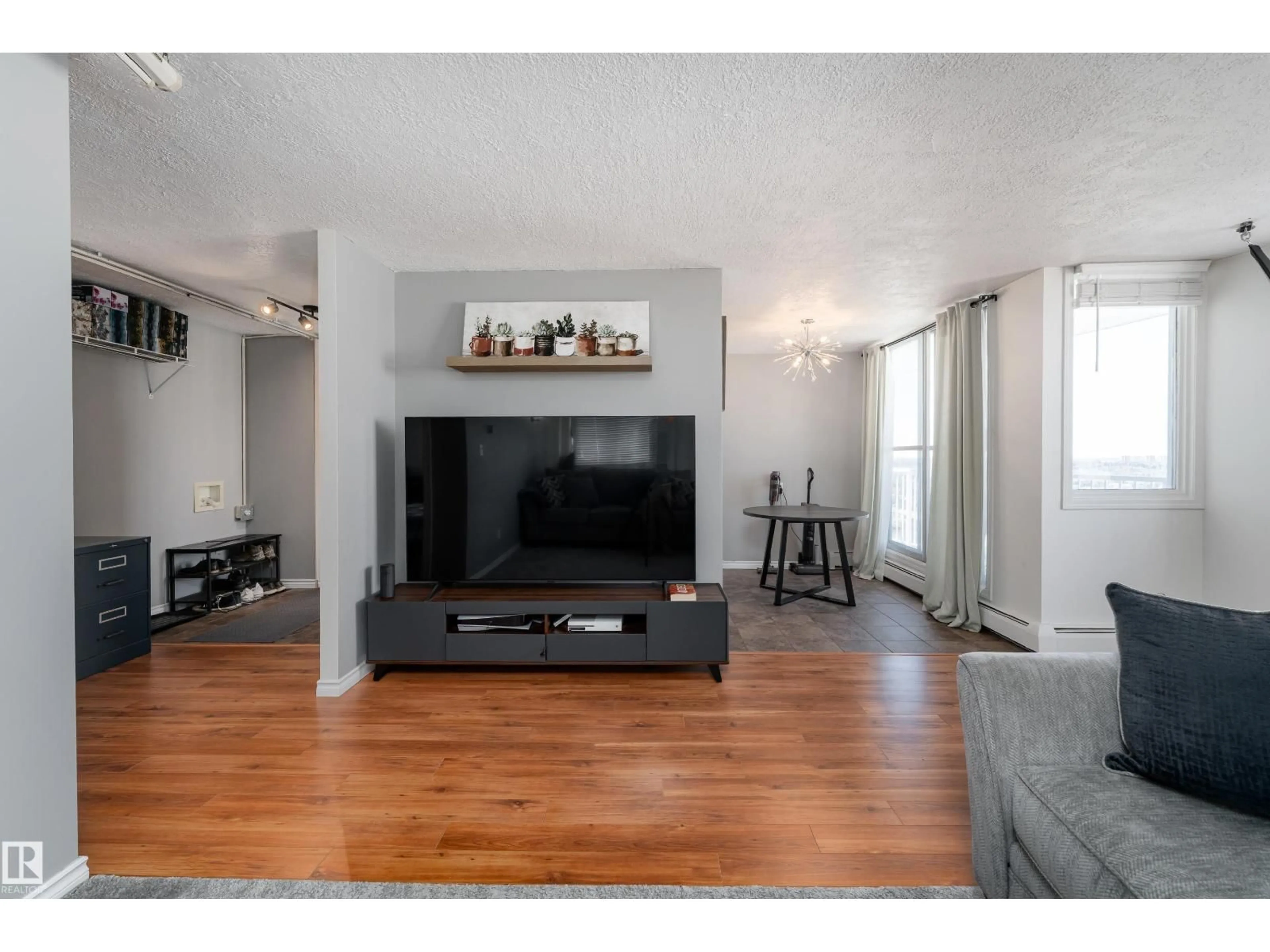 Living room with furniture, wood/laminate floor for #1601 - 12141 JASPER AV, Edmonton Alberta T5N3X8