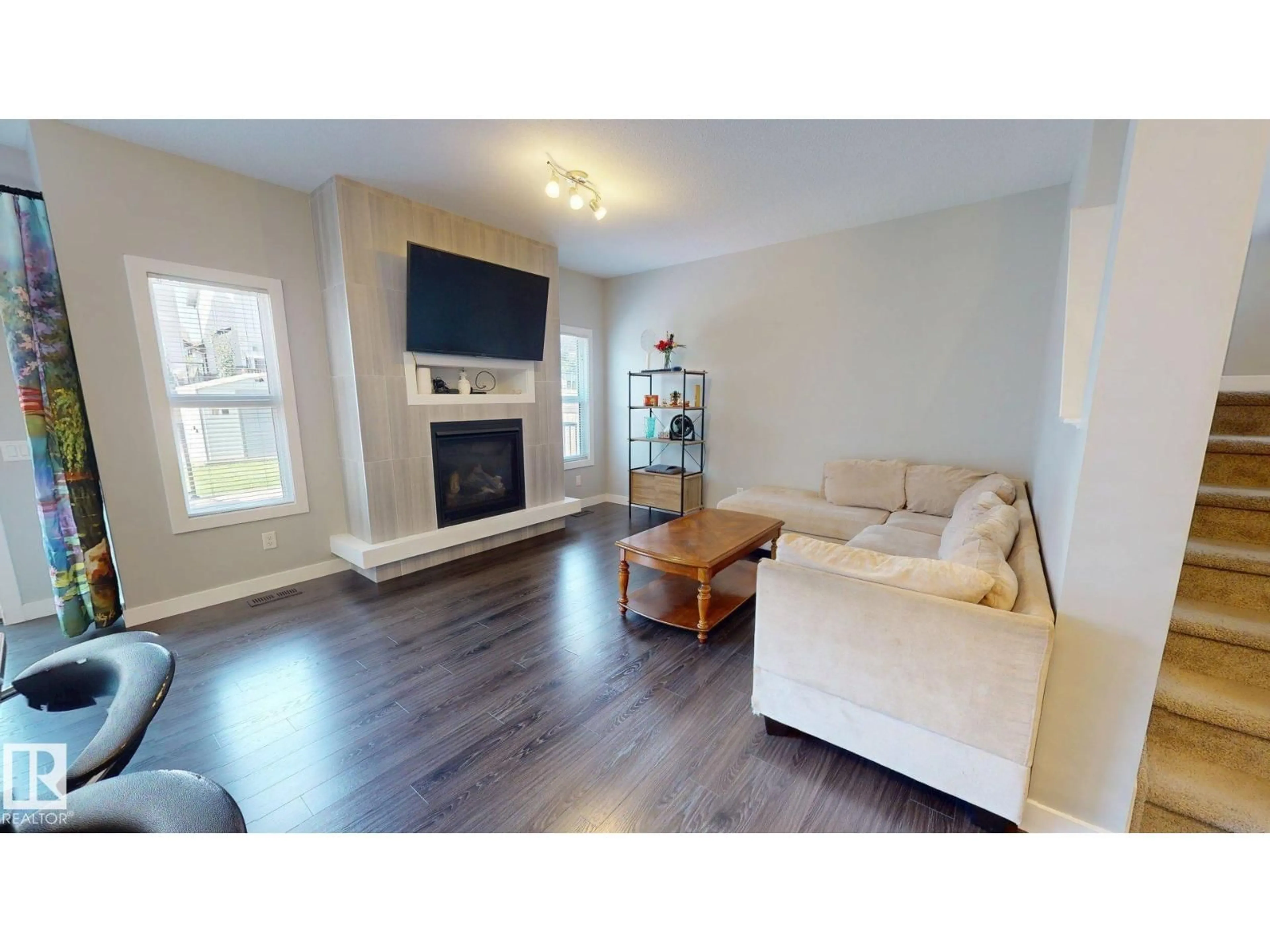 Living room with furniture, wood/laminate floor for NW - 7304 EDGEMONT WY, Edmonton Alberta T6M0S1