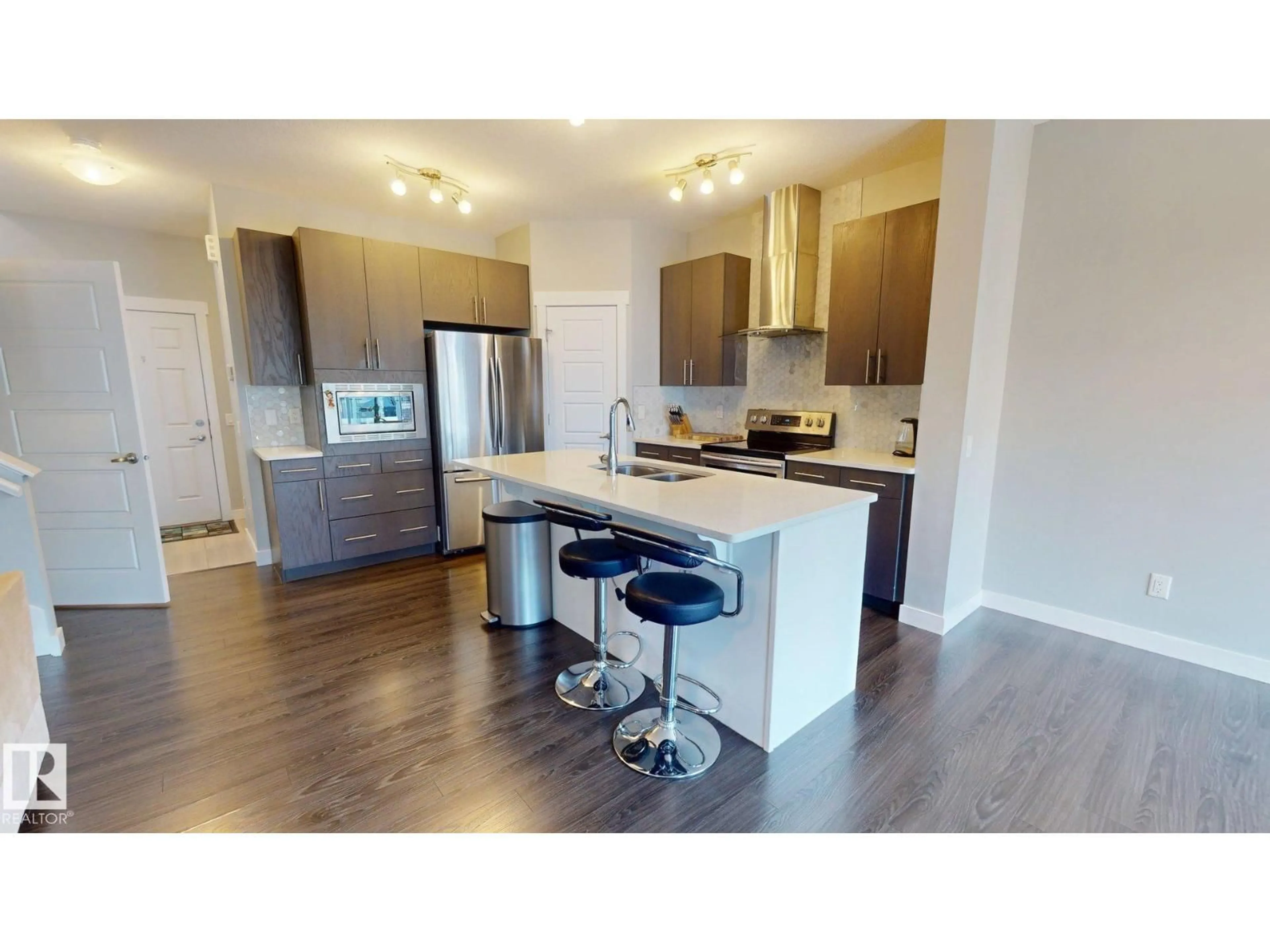 Open concept kitchen, wood/laminate floor for NW - 7304 EDGEMONT WY, Edmonton Alberta T6M0S1