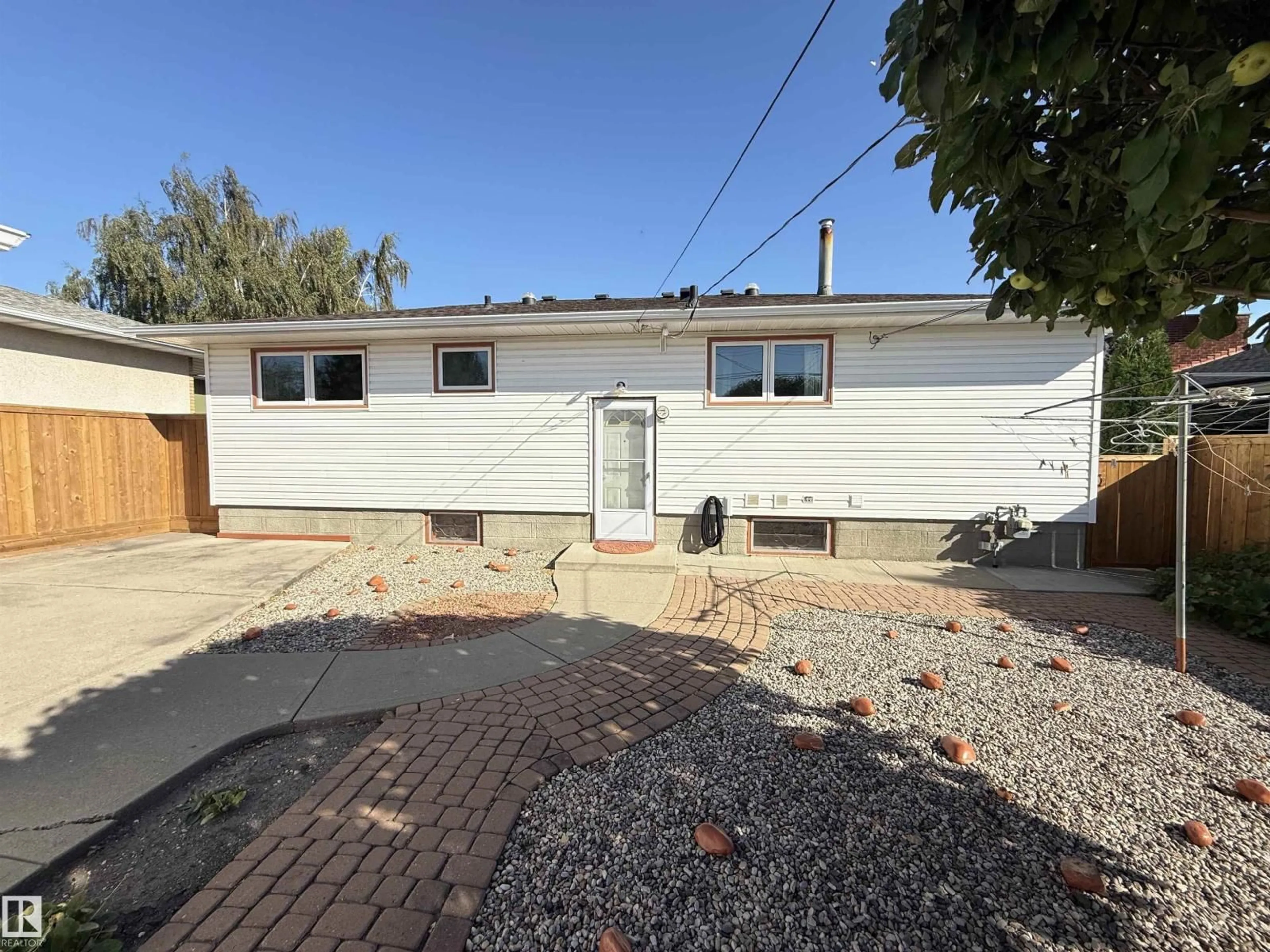 Home with vinyl exterior material, street for 7007 91 AV, Edmonton Alberta T6B0R5