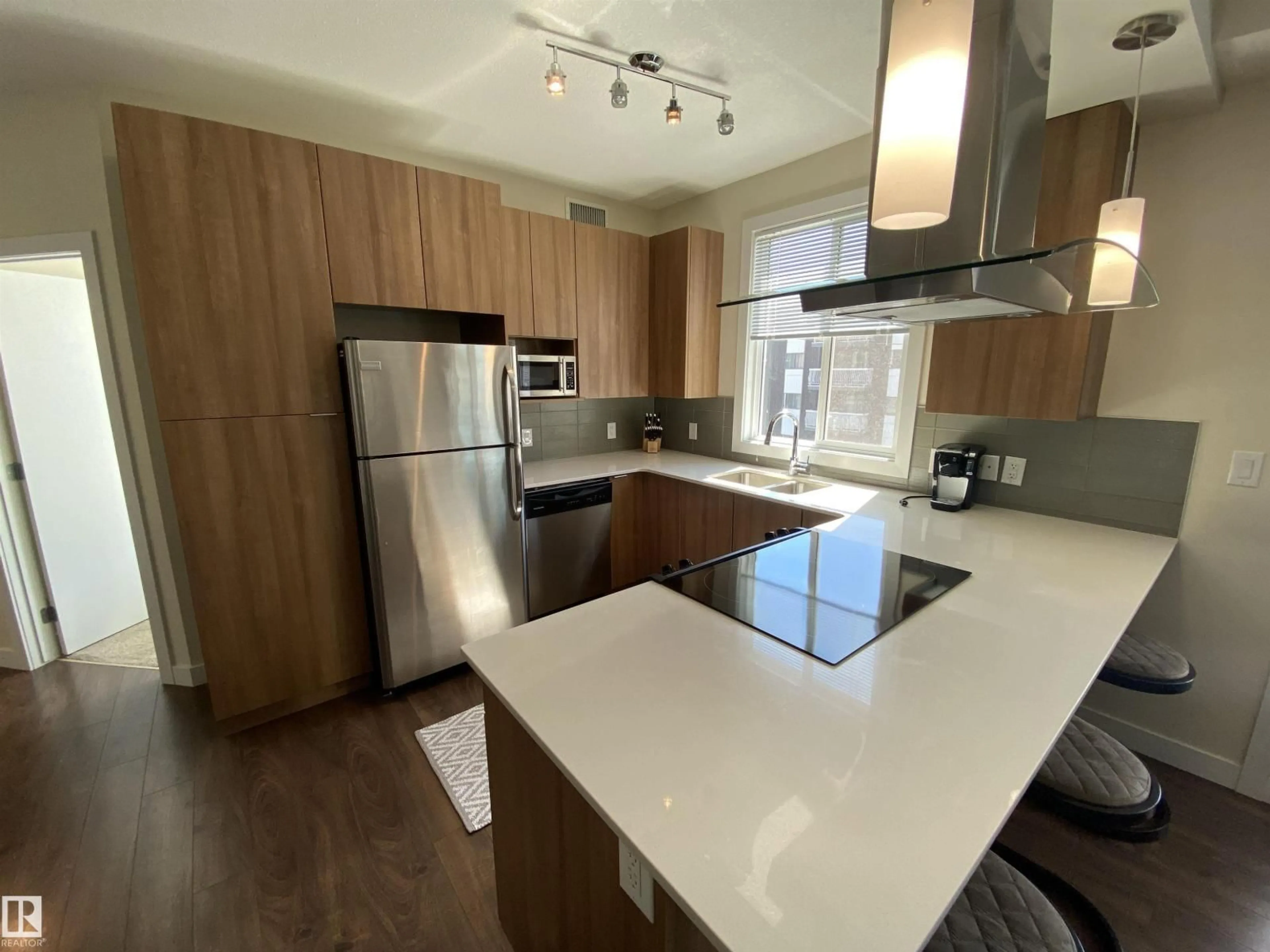 Open concept kitchen, wood/laminate floor for 308 - 9907 91 AV, Edmonton Alberta T6E2T7