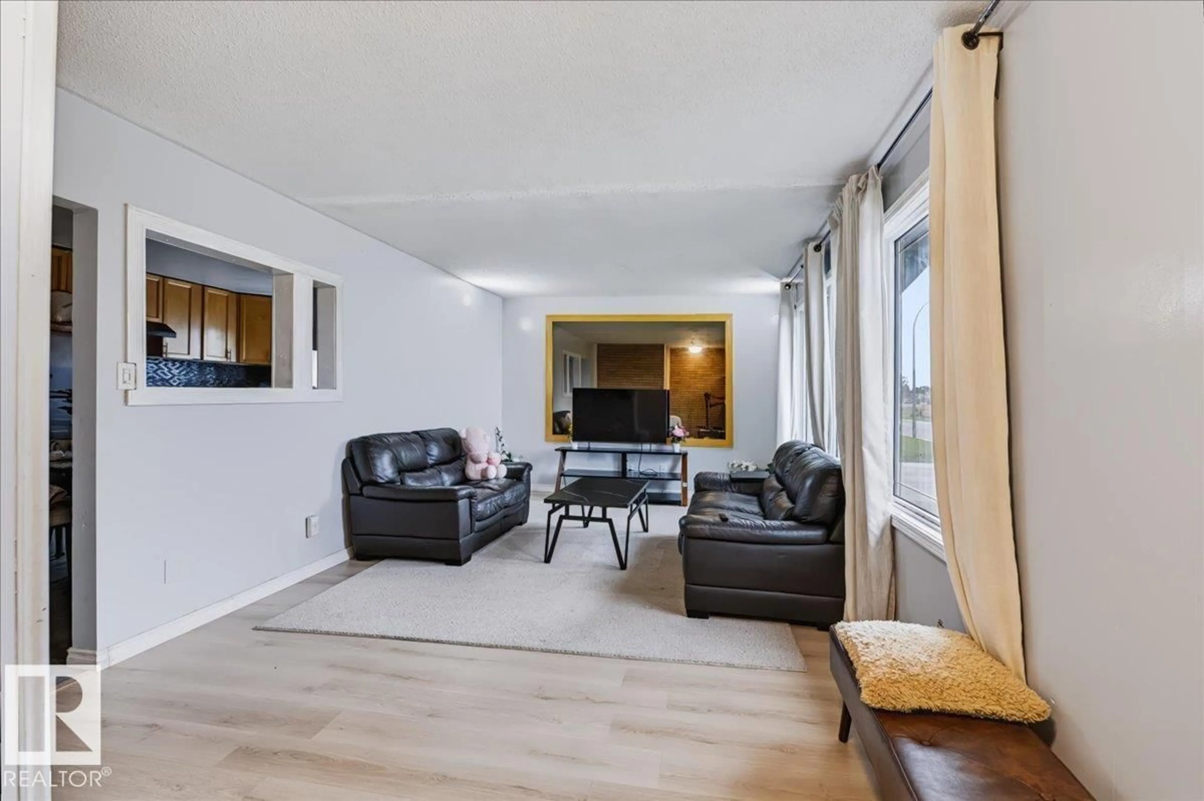 Living room with furniture, wood/laminate floor for 12919 135 AV NW, Edmonton Alberta T5L3X7