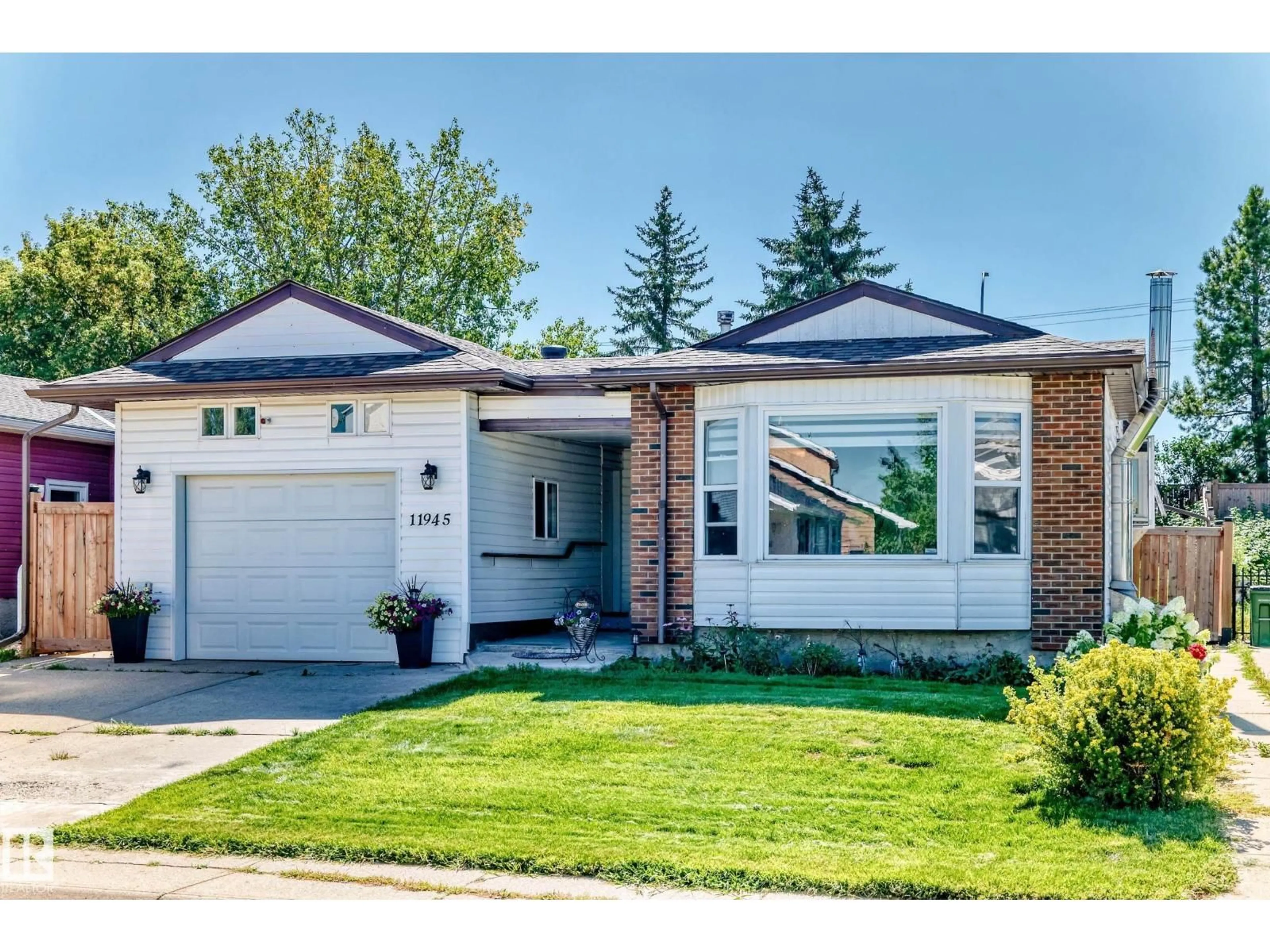 Home with brick exterior material, street for NW - 11945 138 AV, Edmonton Alberta T5X4K1