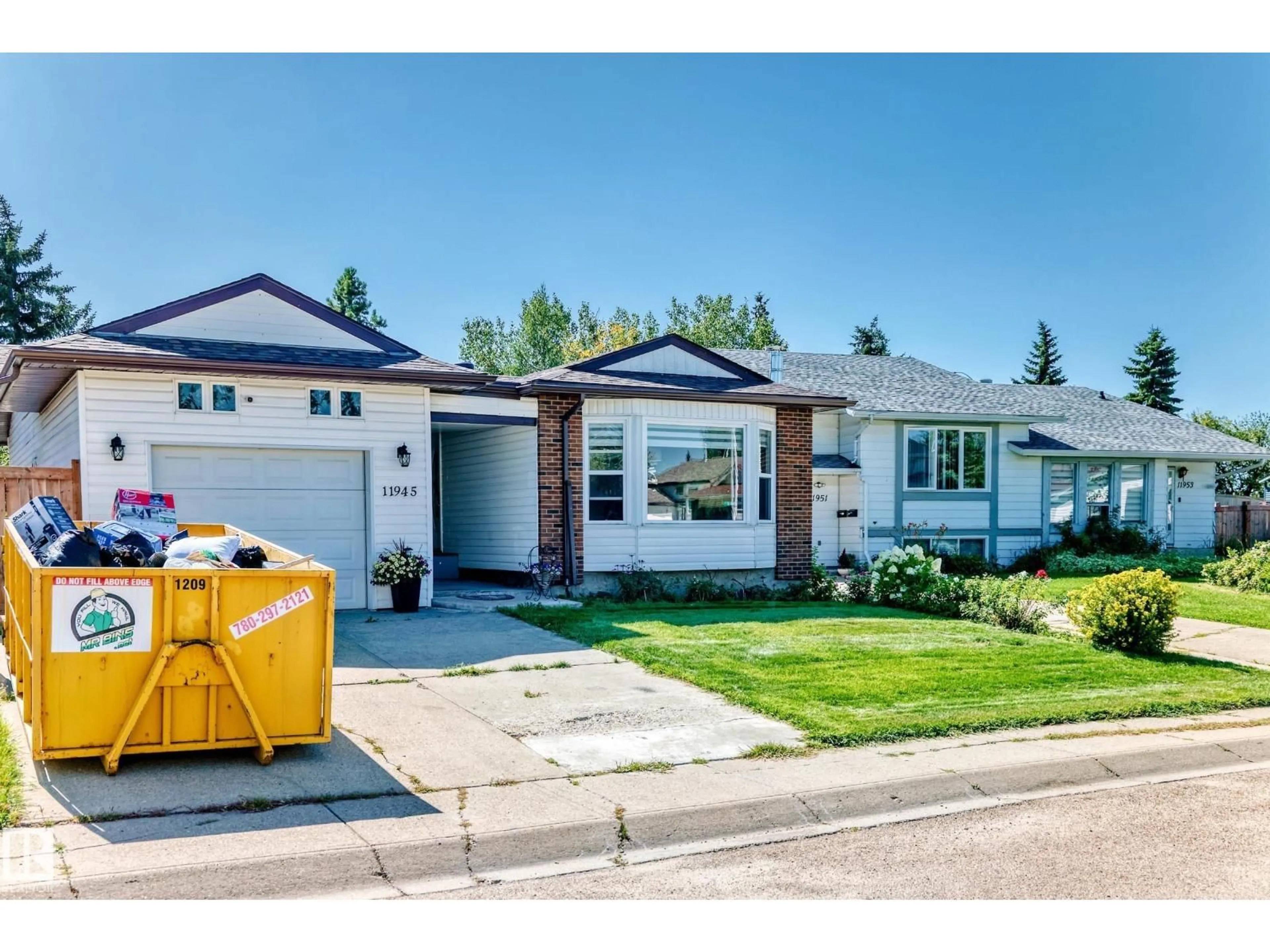 Home with vinyl exterior material, street for NW - 11945 138 AV, Edmonton Alberta T5X4K1