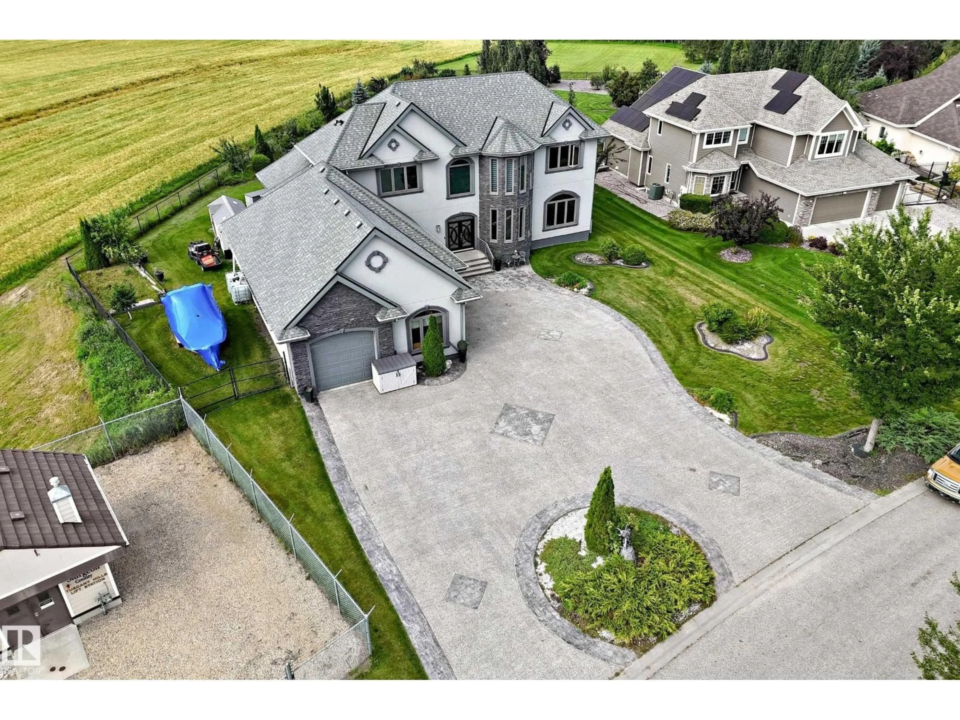 A pic from outside/outdoor area/front of a property/back of a property/a pic from drone, street for 101 - 54302 RGE ROAD 250, Rural Sturgeon County Alberta T8T0C9