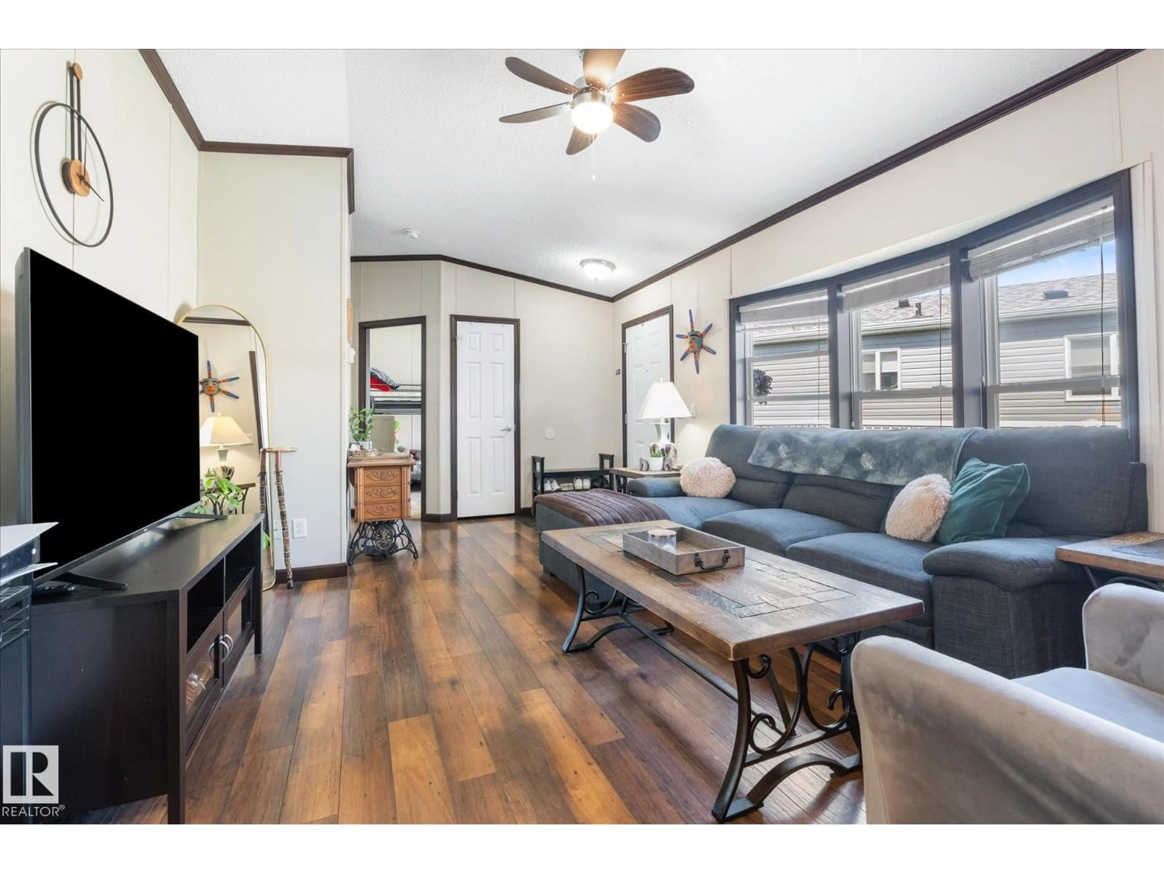 Living room with furniture, wood/laminate floor for 1435 53222 RGE RD RD, Rural Parkland County Alberta T7X4M4