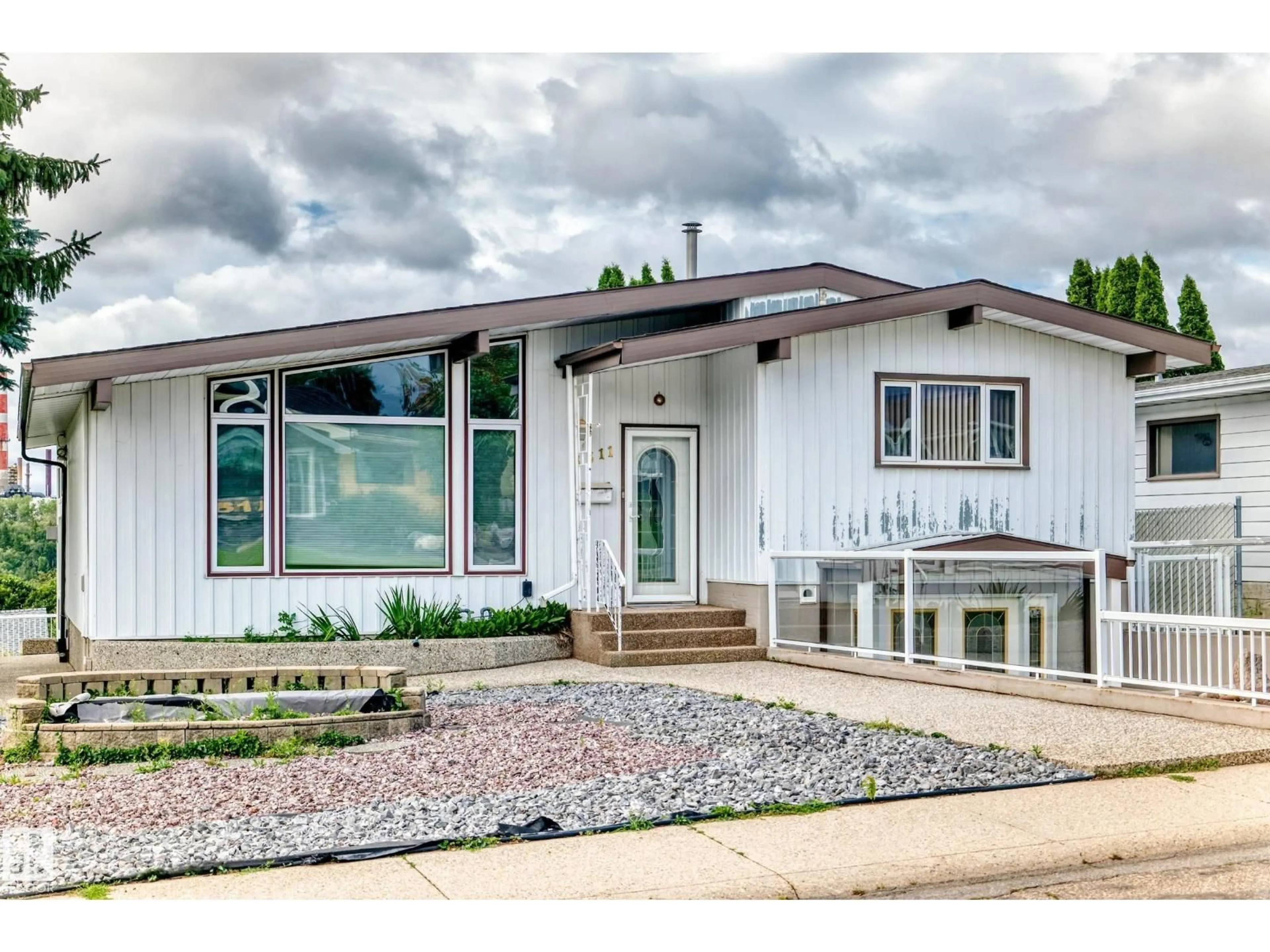 Home with vinyl exterior material, street for 3311 104 AV, Edmonton Alberta T5W0A8