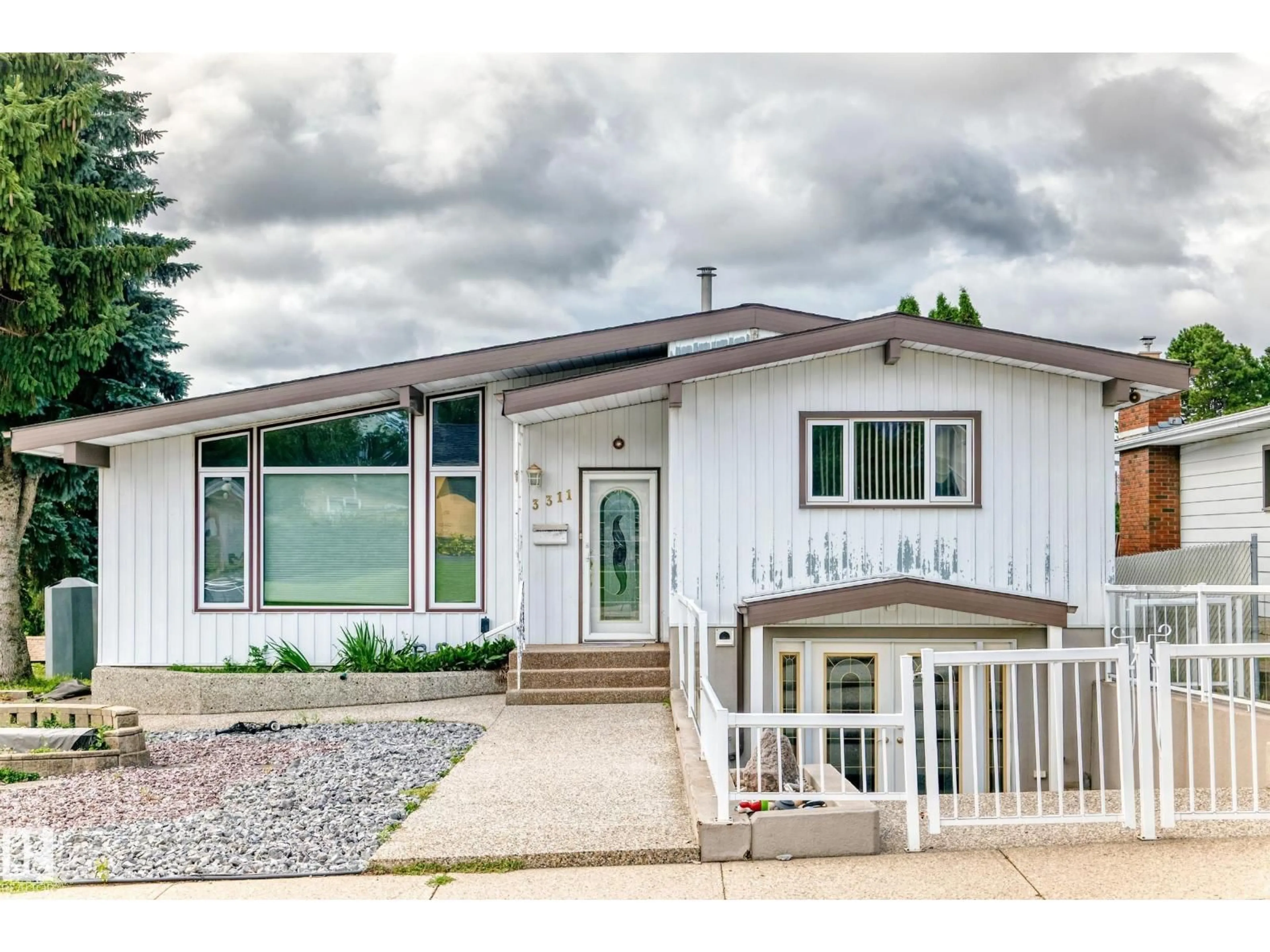 Home with vinyl exterior material, street for 3311 104 AV, Edmonton Alberta T5W0A8