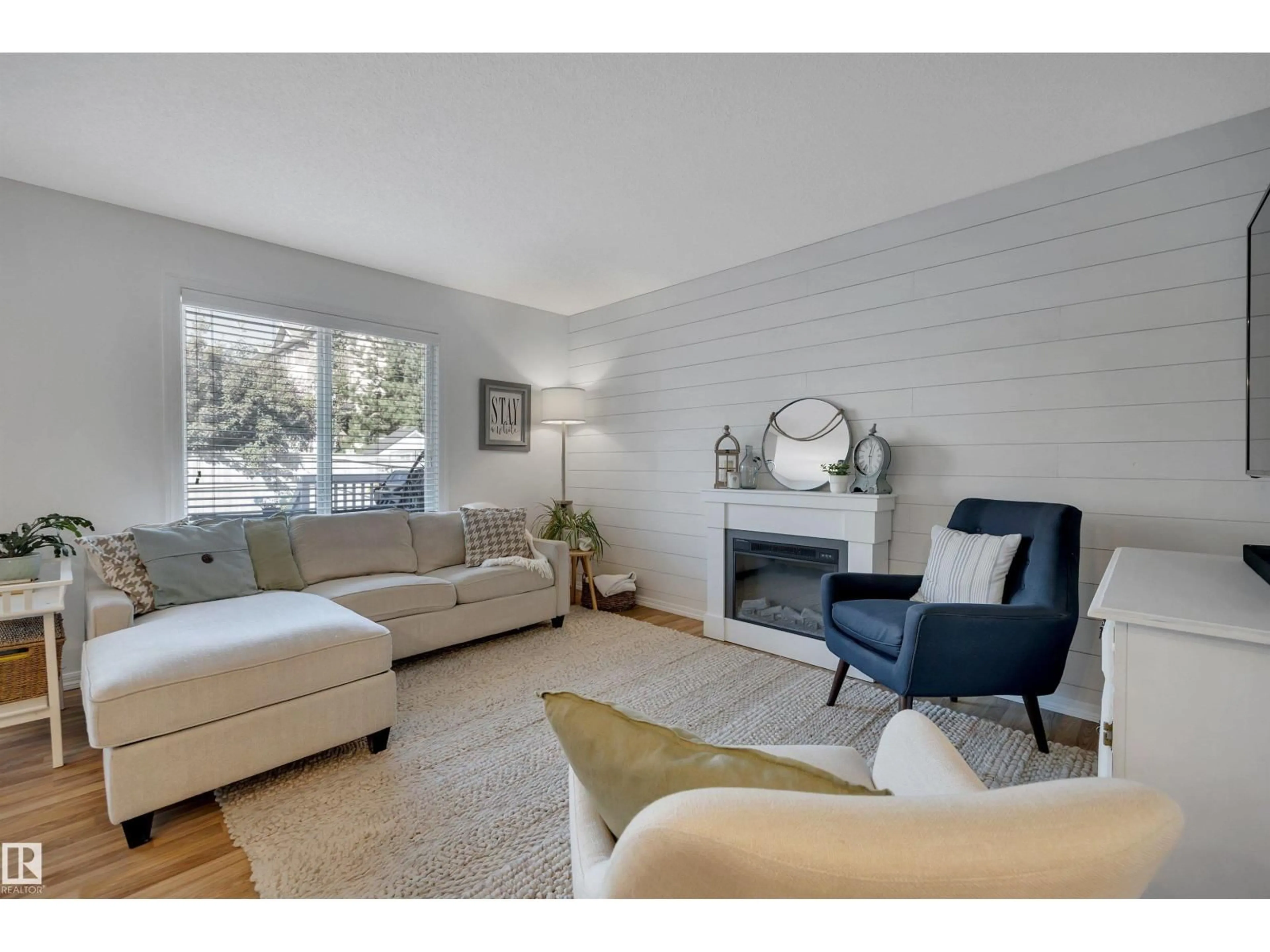 Living room with furniture, wood/laminate floor for 1325 CUNNINGHAM DR, Edmonton Alberta T6W0R8