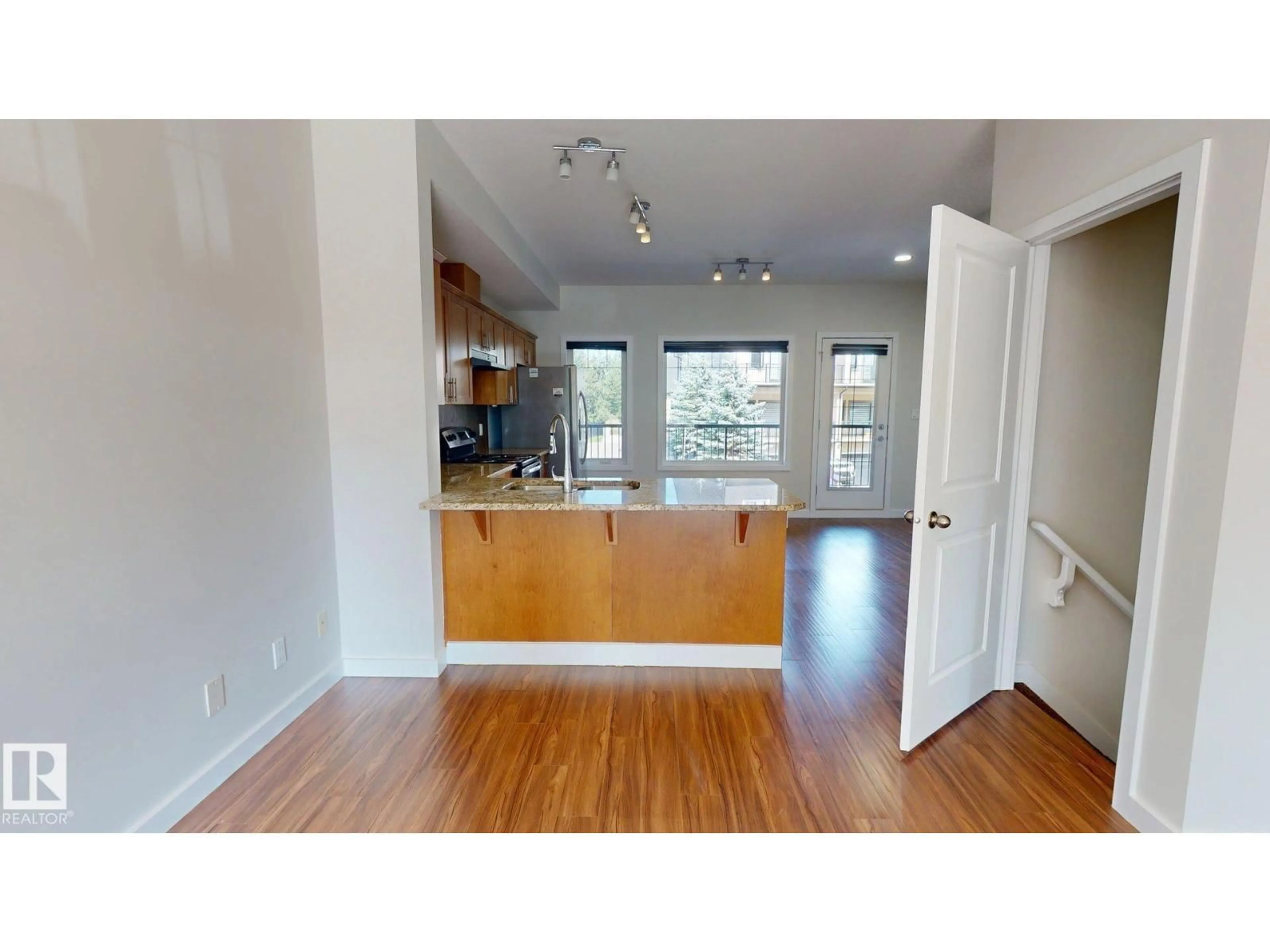 Open concept kitchen, wood/laminate floor for 5833 MULLEN PL, Edmonton Alberta T6R0T5