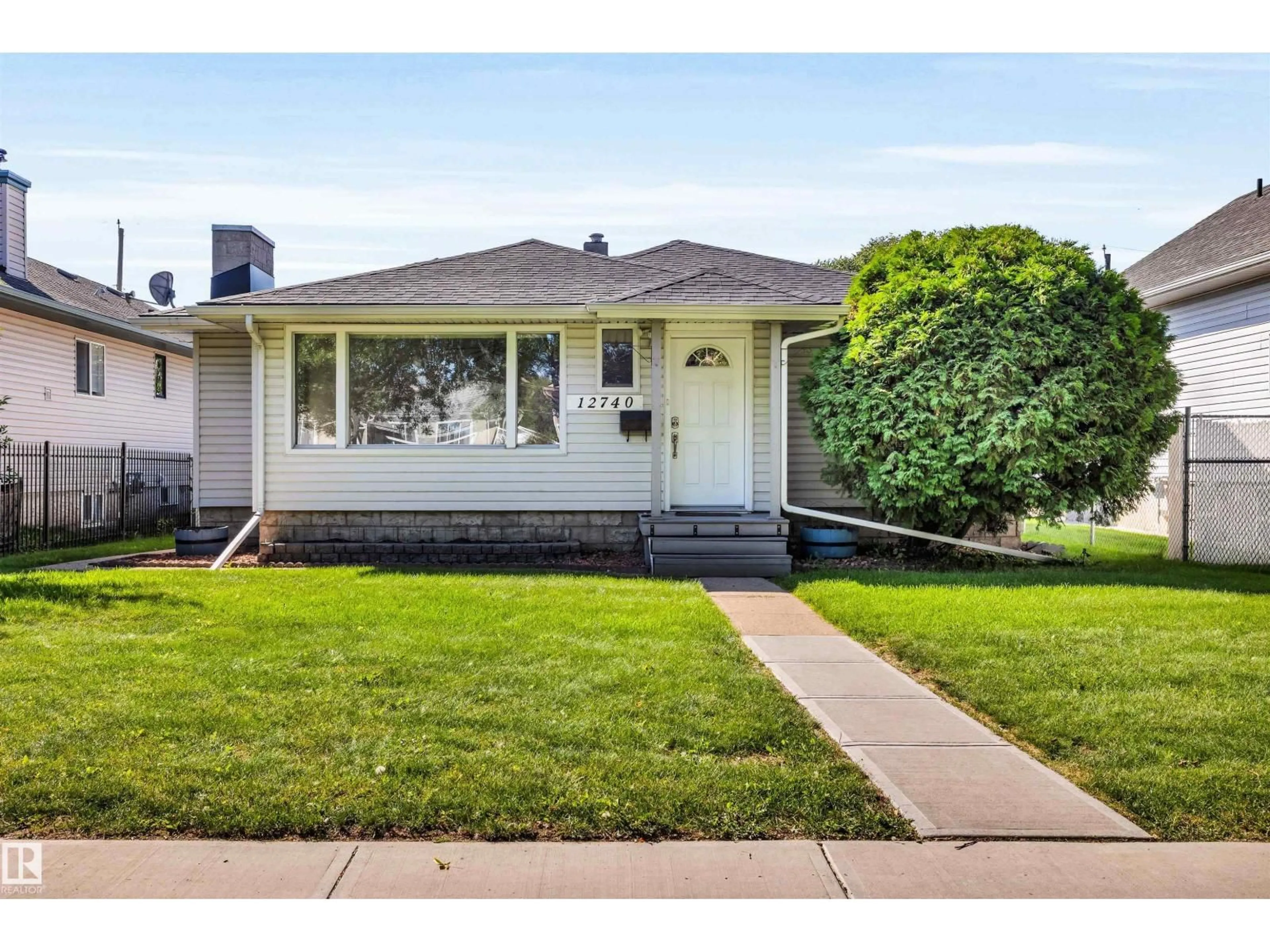 Home with vinyl exterior material, street for 12740 118 ST, Edmonton Alberta T5E5K8